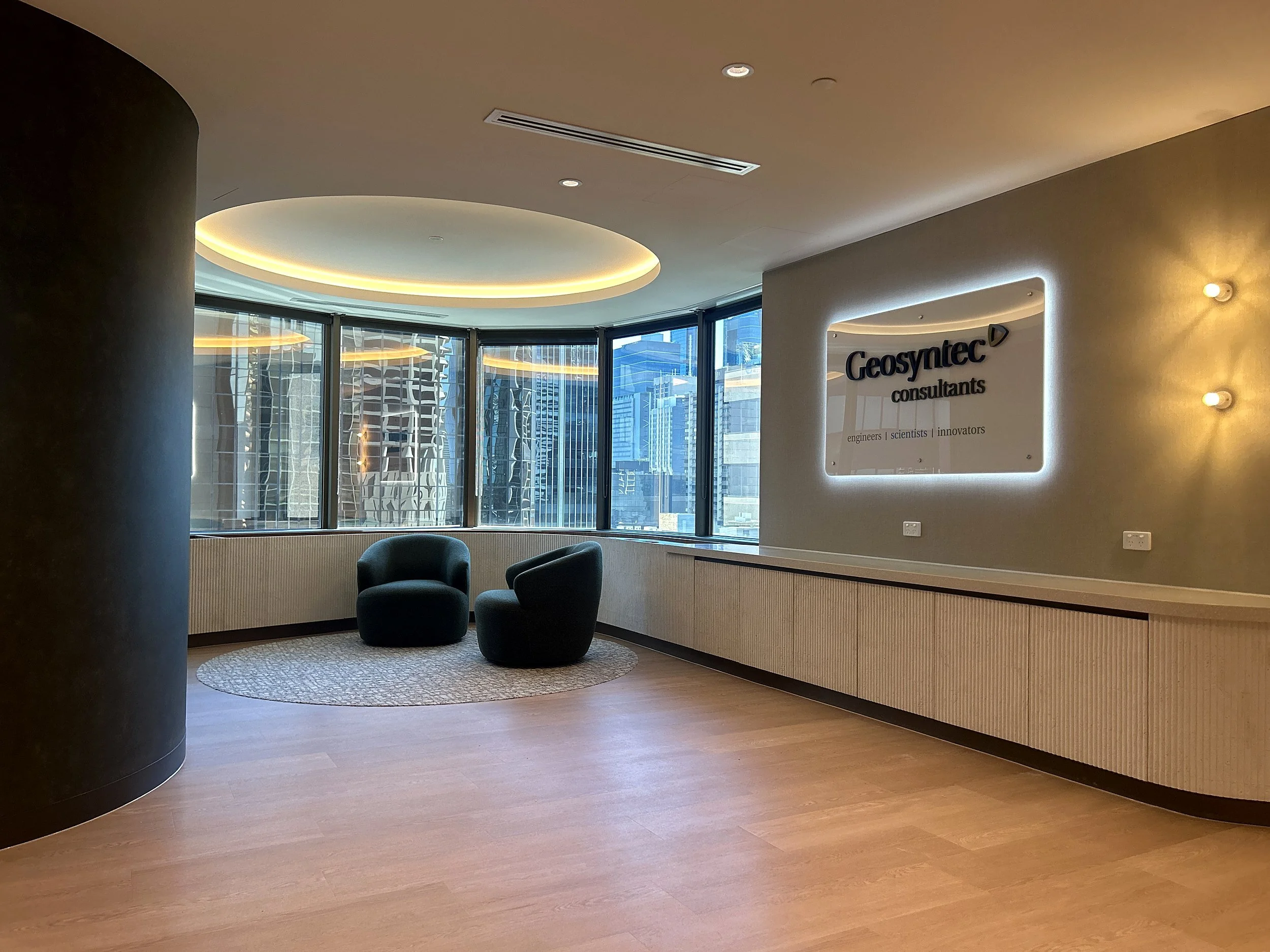Curved reception with lit ceiling at Gold Tower, 10 Eagle Street