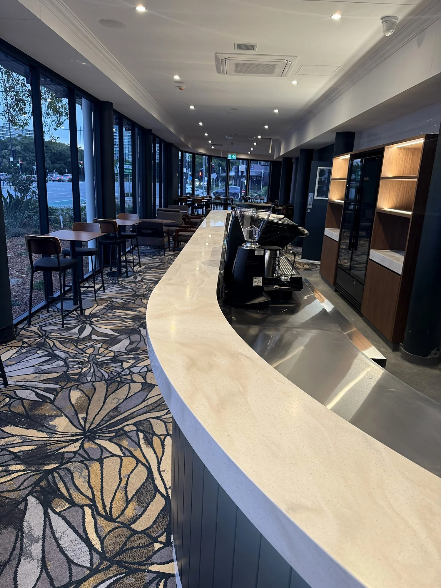 Curved bar beside full height glazing at Hotel Kingsley, Hamilton