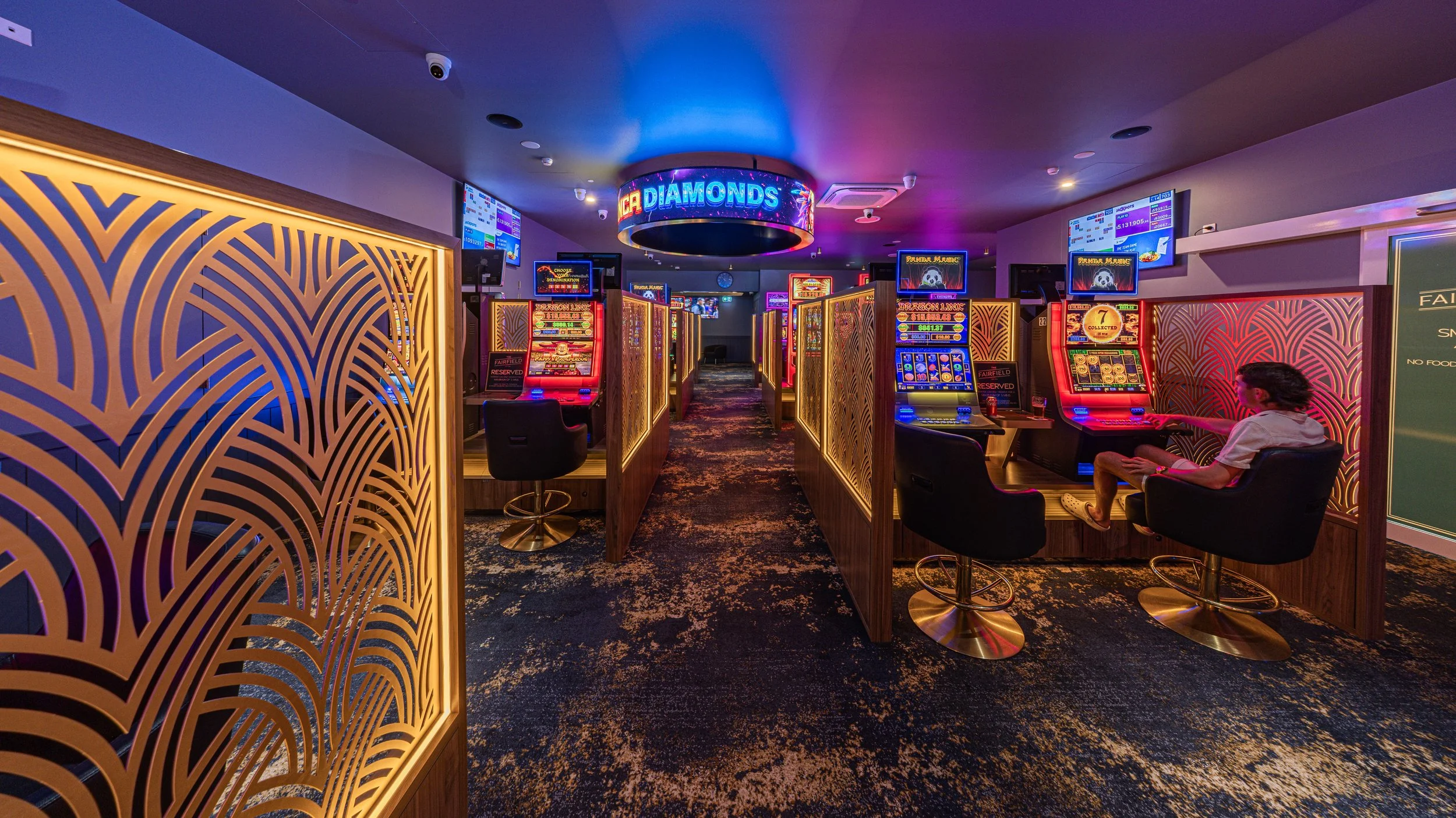 Gaming room with lit timber screens at The Fairfield Hotel, Townsville