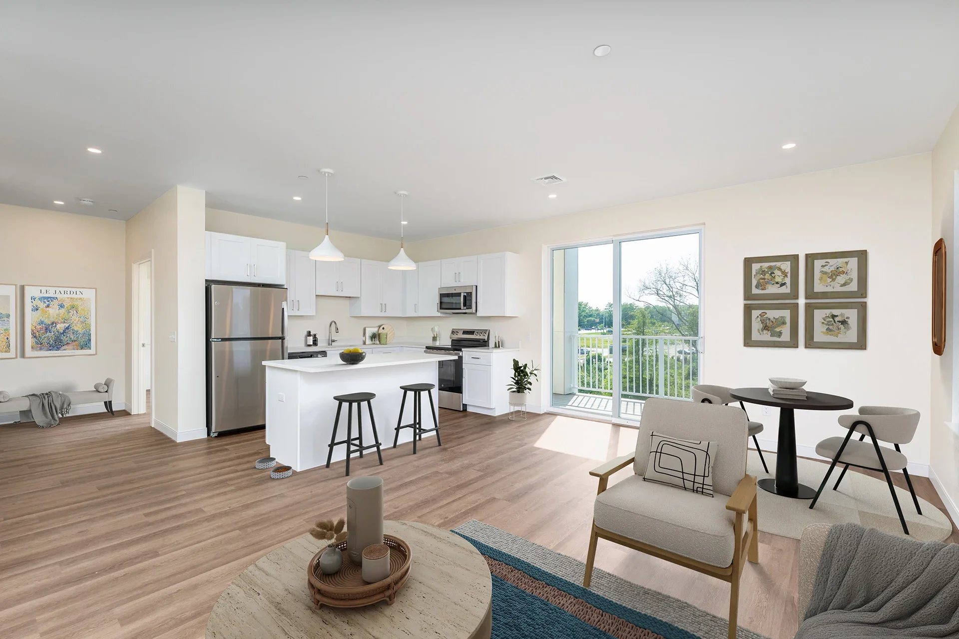 Open-concept living room and kitchen with white cabinets, stainless steel refrigerator, and sliding glass door leading to balcony, with modern furniture and decor.