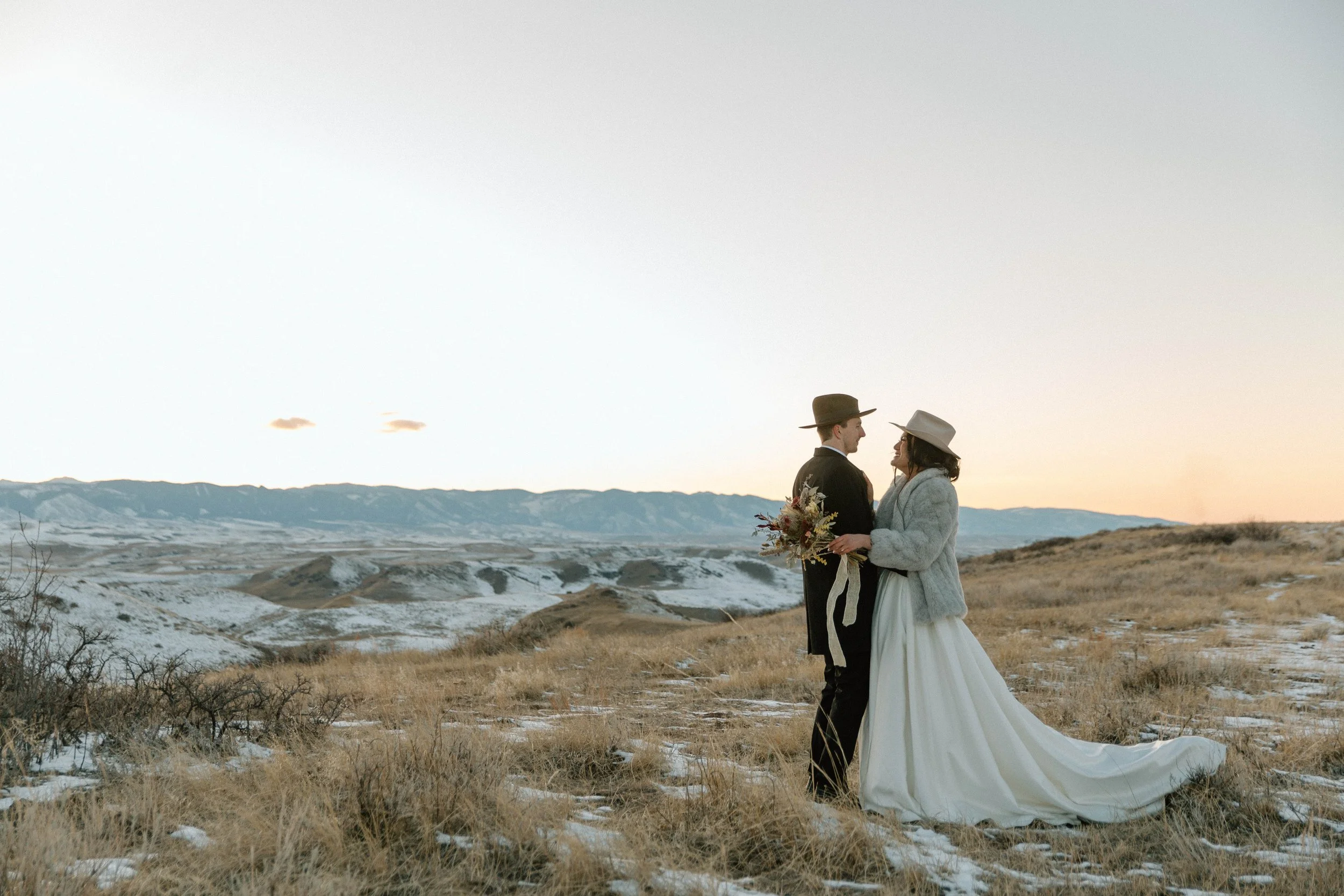 couple standing in front of the bighorn mountains