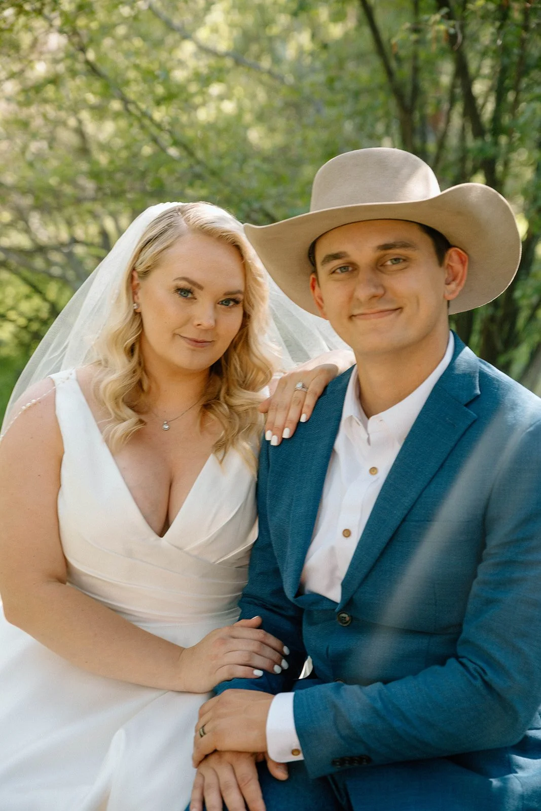 groom-wearing-a-cowboy-hat-at-his-wedding-next-to-his-bride