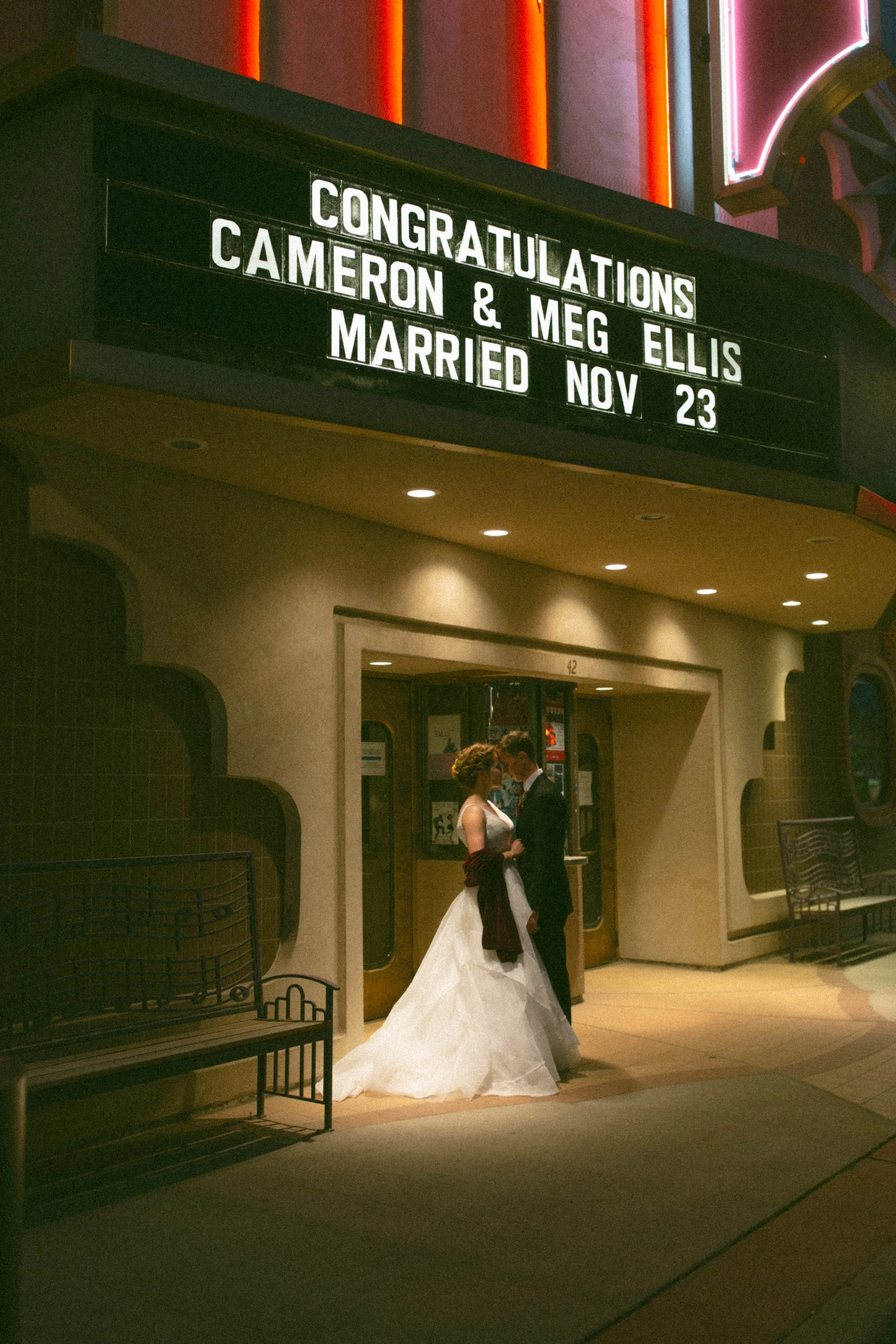 married-couple-standing-in-front-of-the-wyo-theater-in-sheridan-wy