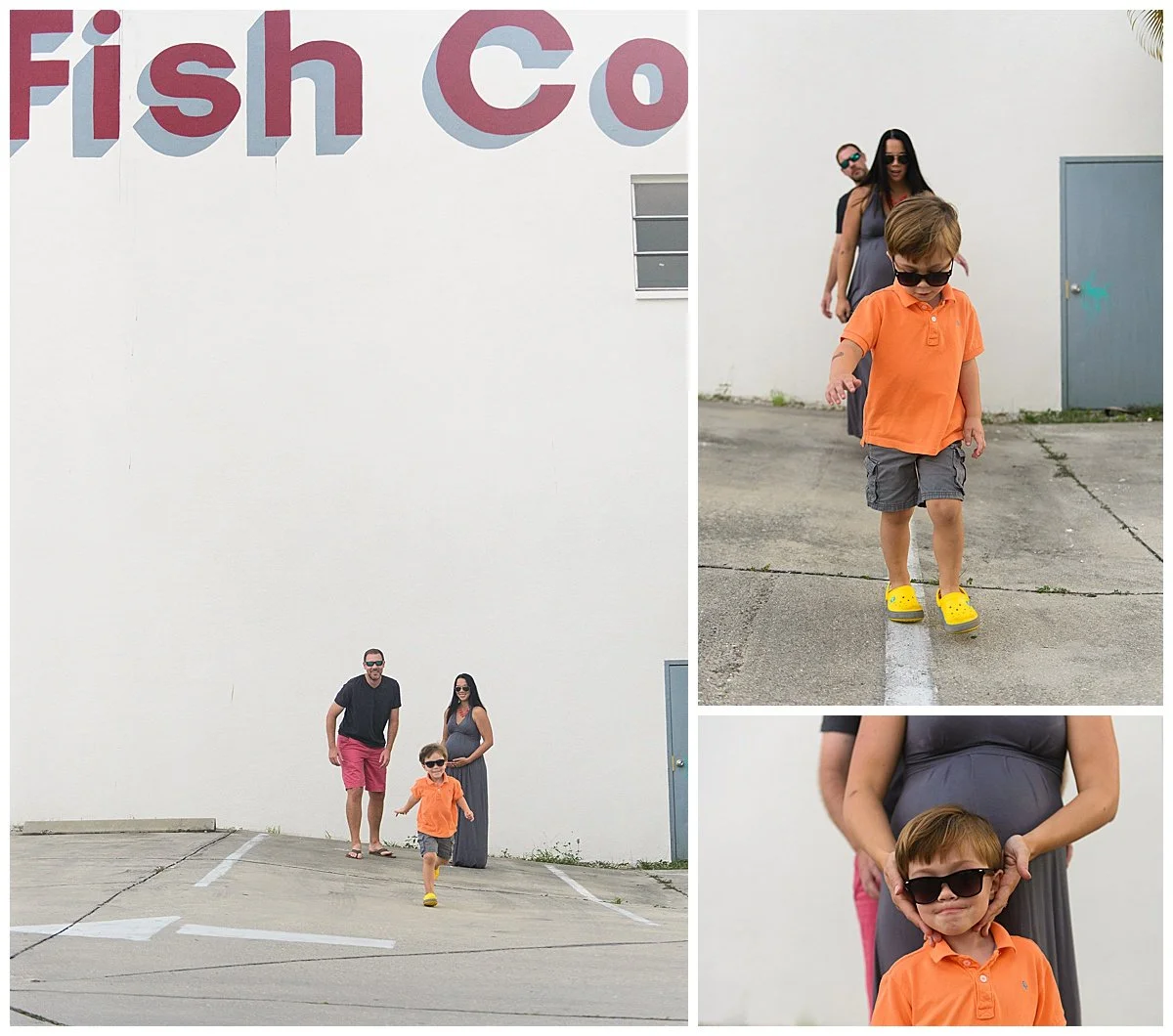 A child in an orange shirt and sunglasses running in a parking lot with two adults following behind against a white wall with partially visible red and blue text.