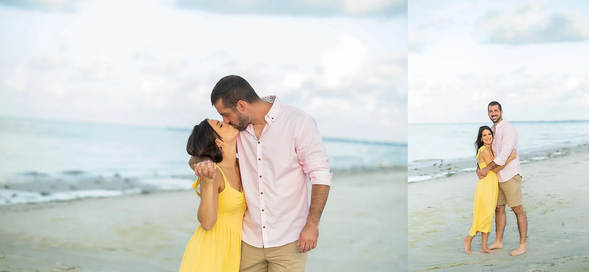 A couple hugging and kissing on a beach, with the woman in a yellow dress and the man in a pink shirt and beige shorts, under a partly cloudy sky.
