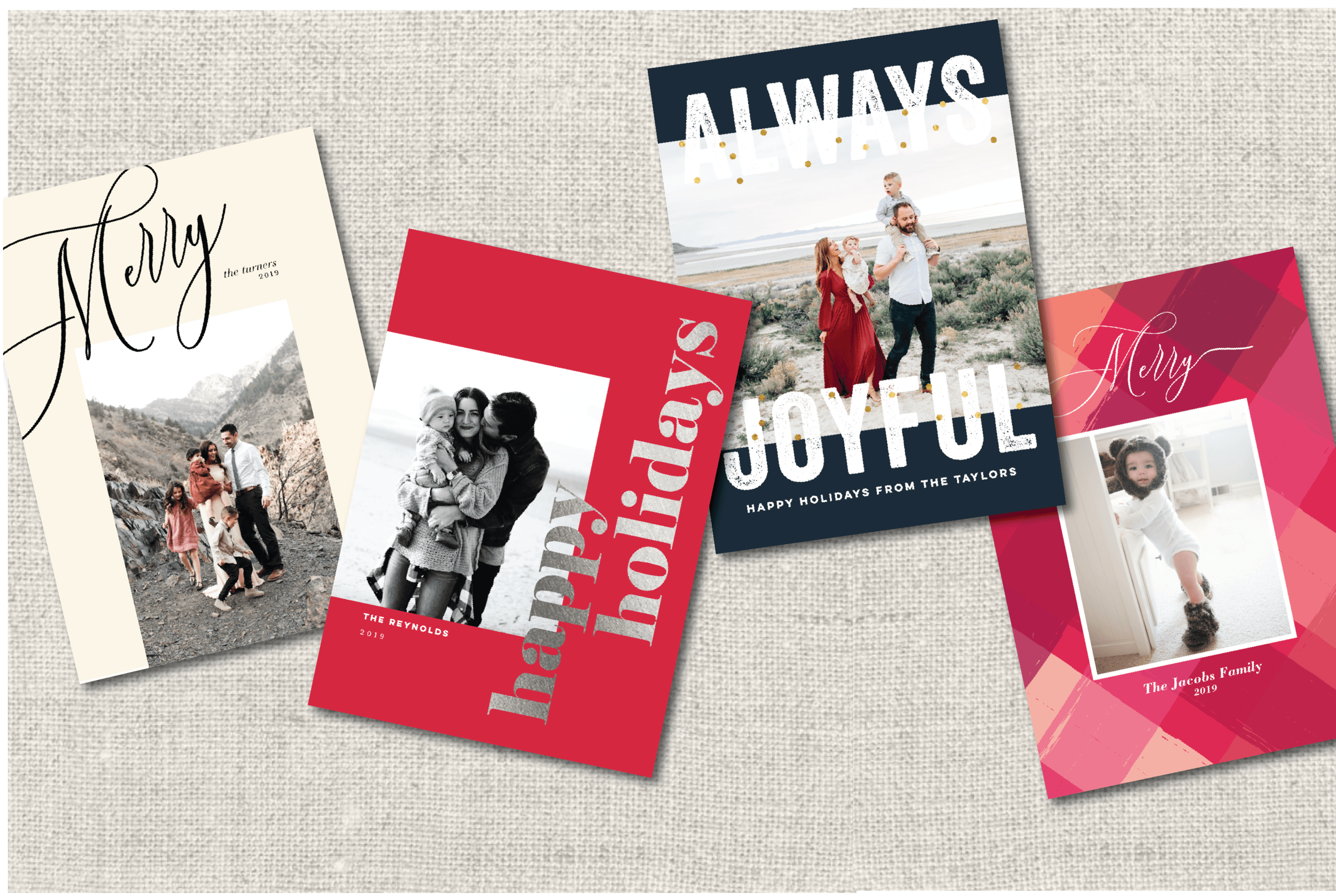 Five holiday greeting cards on a beige textured surface. The cards feature family photos and festive messages such as "Always Joyful," "Happy Holidays," and "Merry," with personalized text including family names and year 2019.