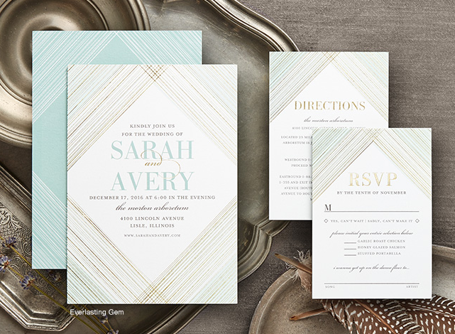 Wedding invitation and RSVP cards for Sarah and Avery with a geometric gold and mint design, placed on a textured grey surface with decorative metal and feathers.