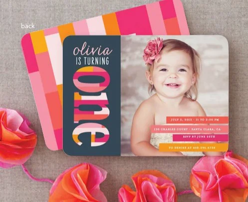 Colorful birthday invitation card with a smiling girl, birthday details, and flowers.
