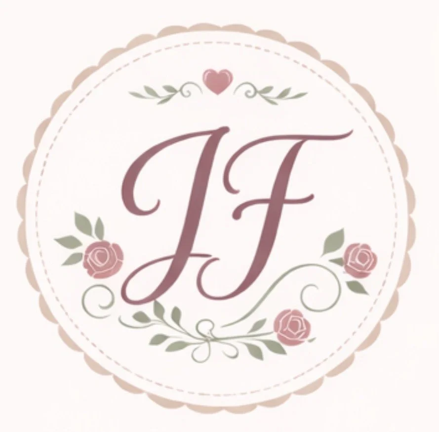 A decorative circular logo with pink roses, green leaves, a small pink heart at the top, and the initials 'J F' in the center in script font.