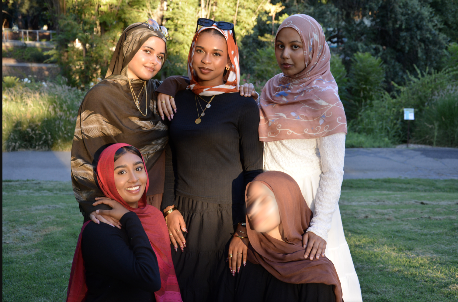 Five hijabis standing together in unity and beautifully representing their face while simultaneously celebrating each other's differences in culture