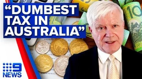 A man with white hair wearing a dark suit and tie, with Australian paper currency and coins in the background, and a blue banner with white text that says 'DUMBEST TAX IN AUSTRALIA' along with the 9 News logo.