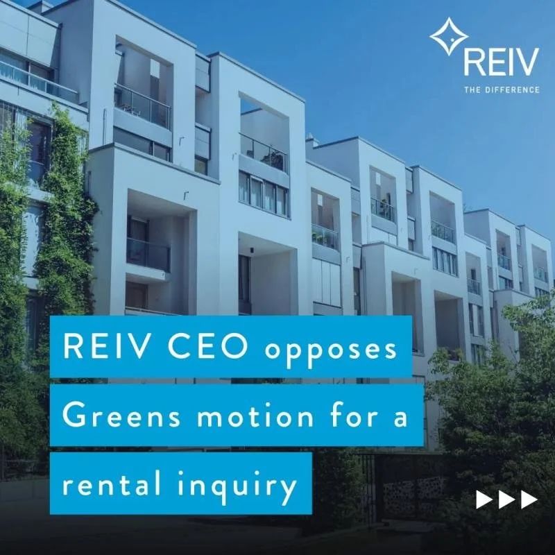 Modern white multi-story residential building with balconies and greenery, under a clear blue sky, REIV logo, and text overlay stating "REIV CEO opposes Greens motion for a rental inquiry."