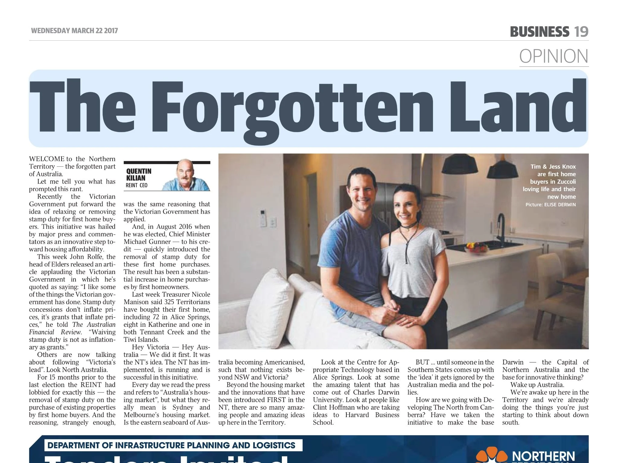 A newspaper article titled "The Forgotten Land" with a photo of a smiling couple sitting in a modern kitchen. The woman has dark hair, and the man has short dark hair. The kitchen features a white counter with a black faucet, black hanging lights, and minimalistic design.