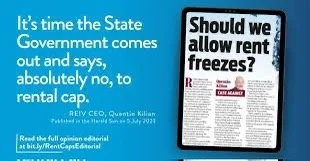 A digital sign or screen with text debating whether rent should be allowed to be frozen, with the headline 'Should we allow rent freeze?'. Additional text mentions the state's government stance on rental caps and references an editorial by REI Co-op, Quenton Killian.