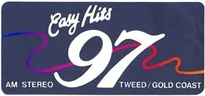 Radio station logo for Candy Hits 97 in Tweed Gold Coast with stylized purple and red swooshes and white text.