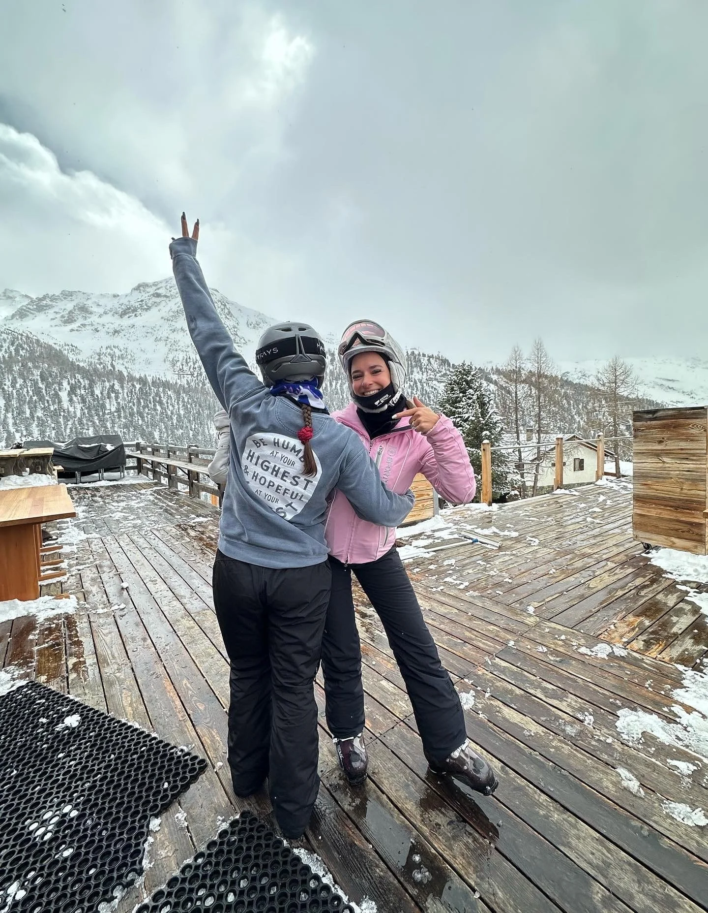 Sarah and a friend showing off their Coastal Yogi gear near a ski mountain.