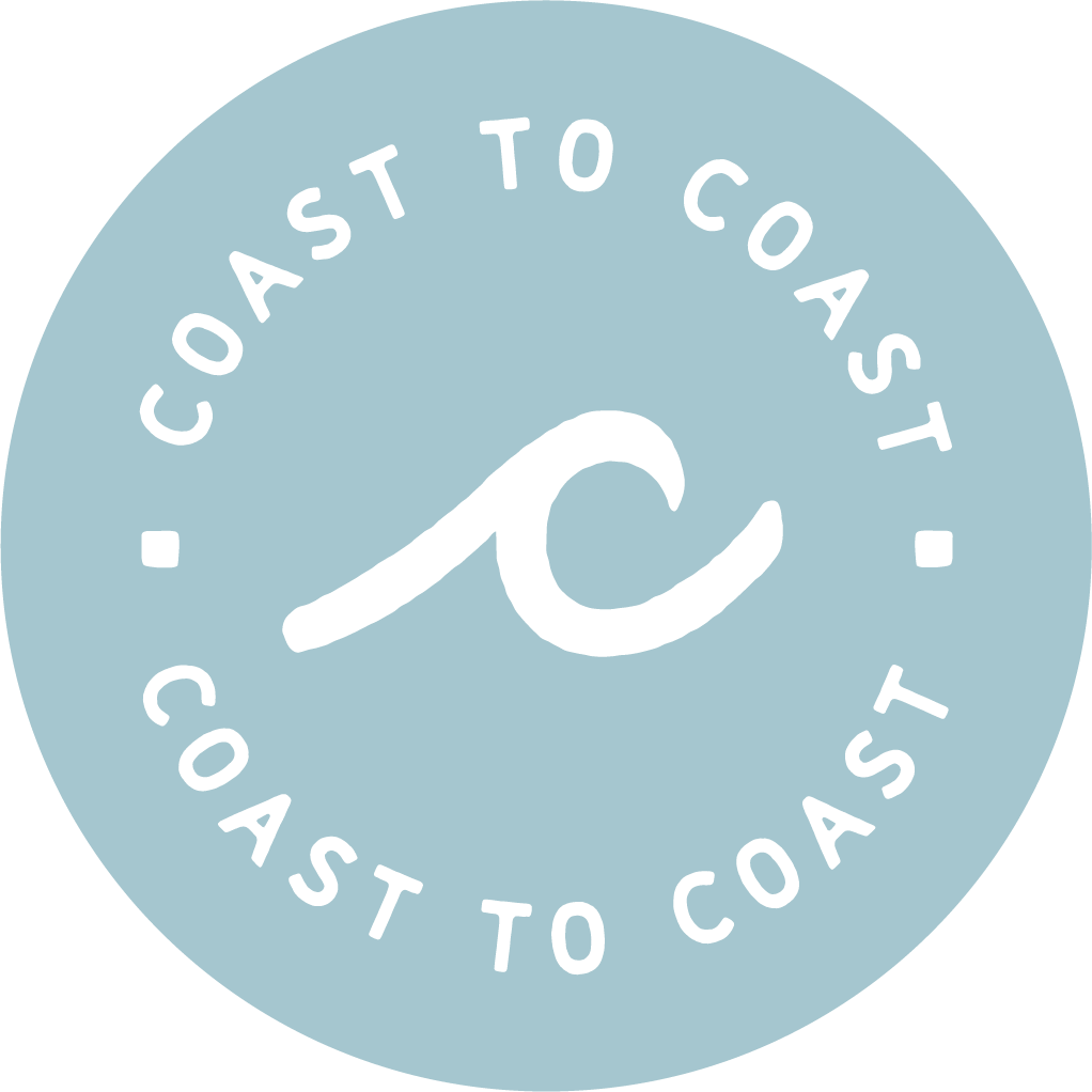 A circular logo with a light blue background and black text that reads "Coast to Coast to Coast". There is a stylized black wave or curving line in the center of the circle.