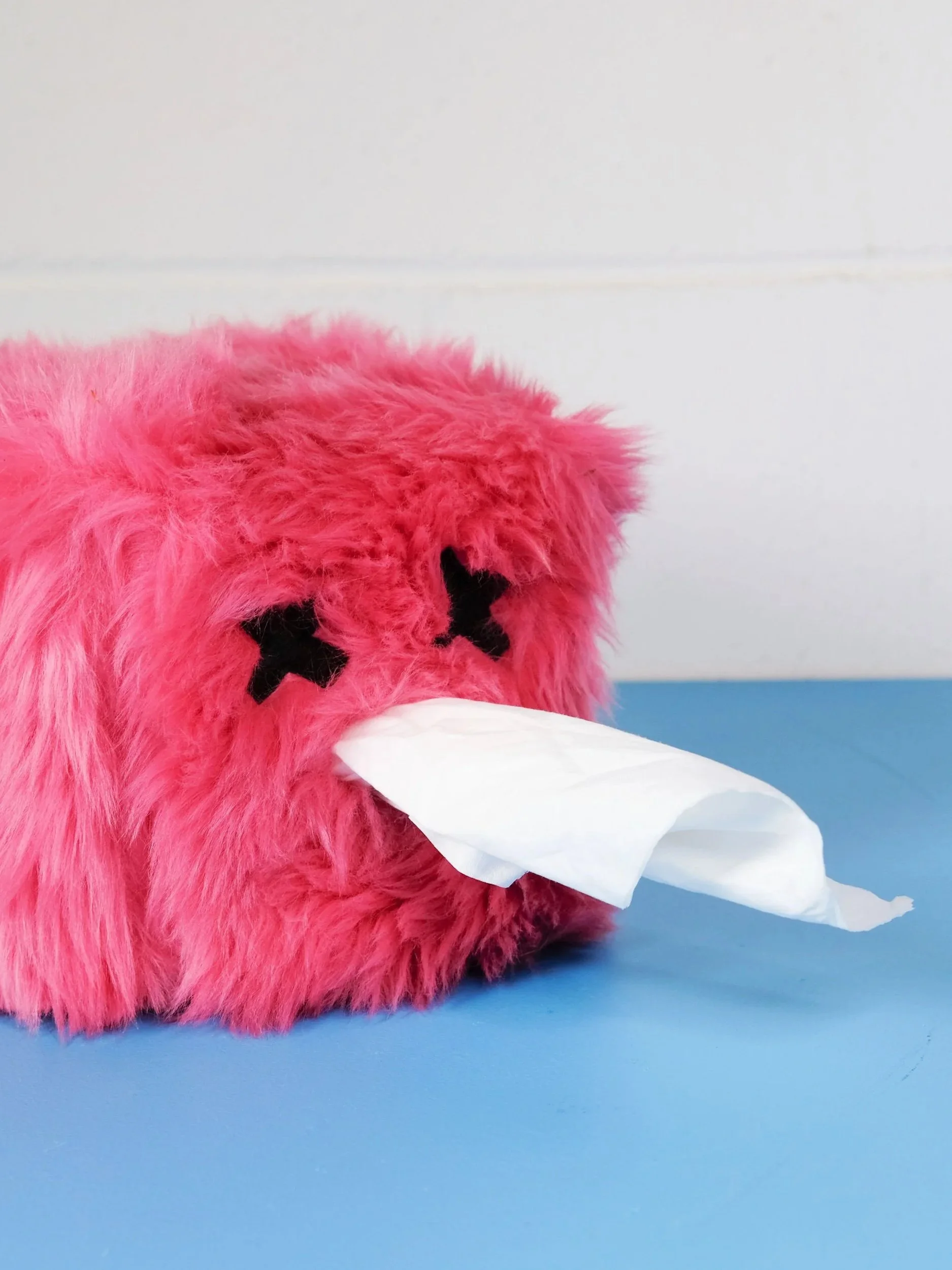 A pink fluffy tissue cosie