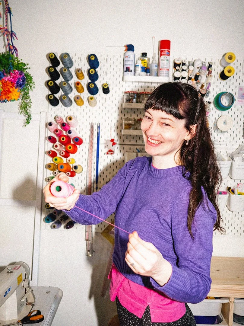 Photograph of Maddles smiling in her studio