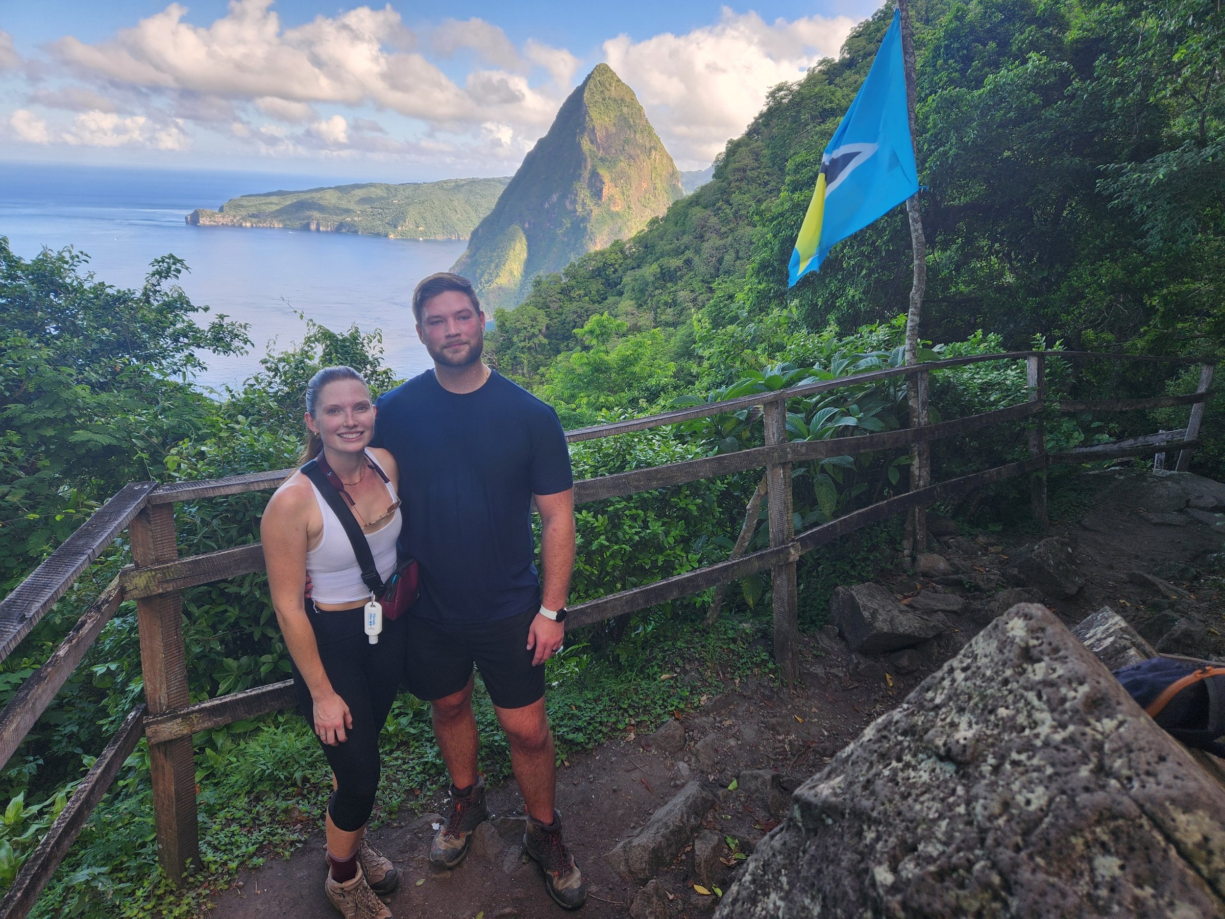 Nick and Brooke hiking Gros Piton in St. Lucia, overlooking the dramatic Caribbean landscape with the iconic Petit Piton in the background