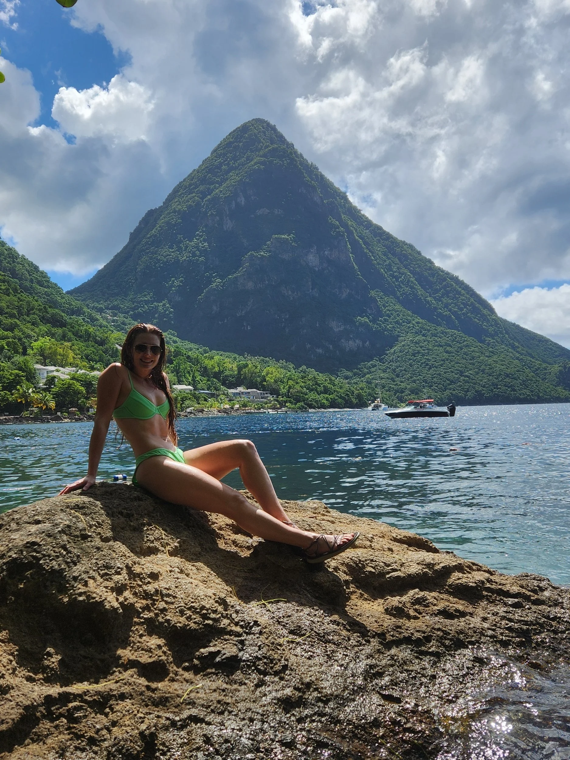 Brooke standing in front of Gros Piton with the turquoise waters of Sugar Bay in St. Lucia.