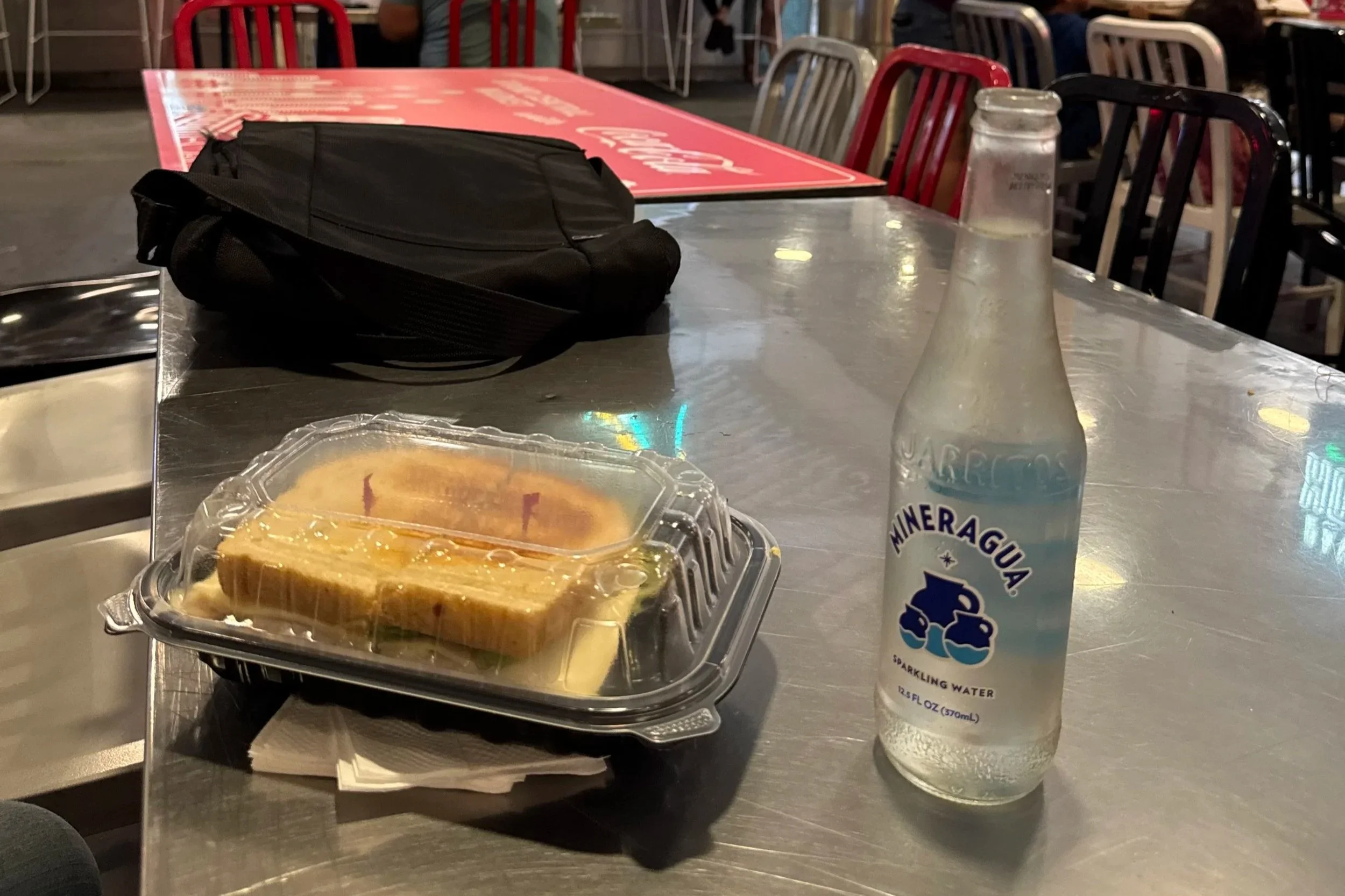 Photo of Turkey Avocado Club Sandwich and sparkling water on table where the seven jurors shared lunch.