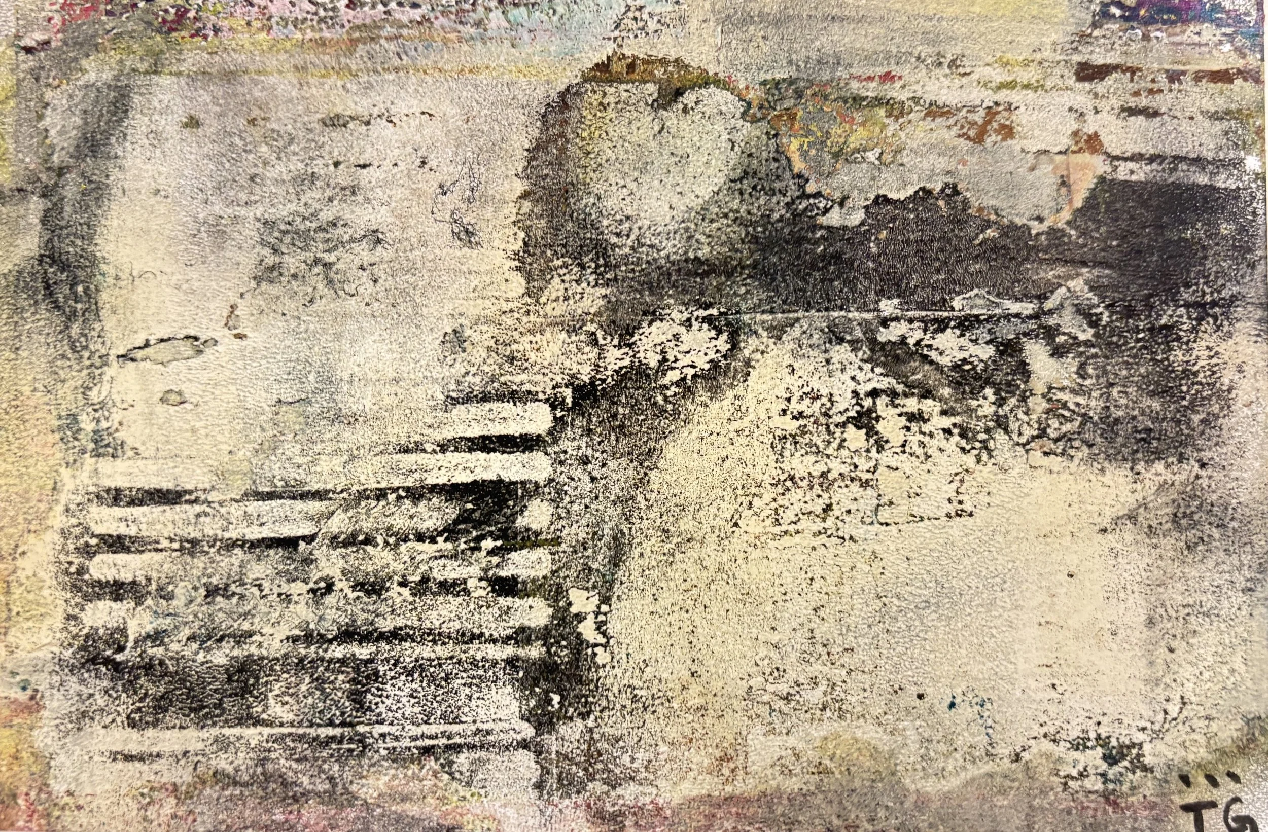 Close-up view of a textured surface with black and white paint and some scribbled patterns.