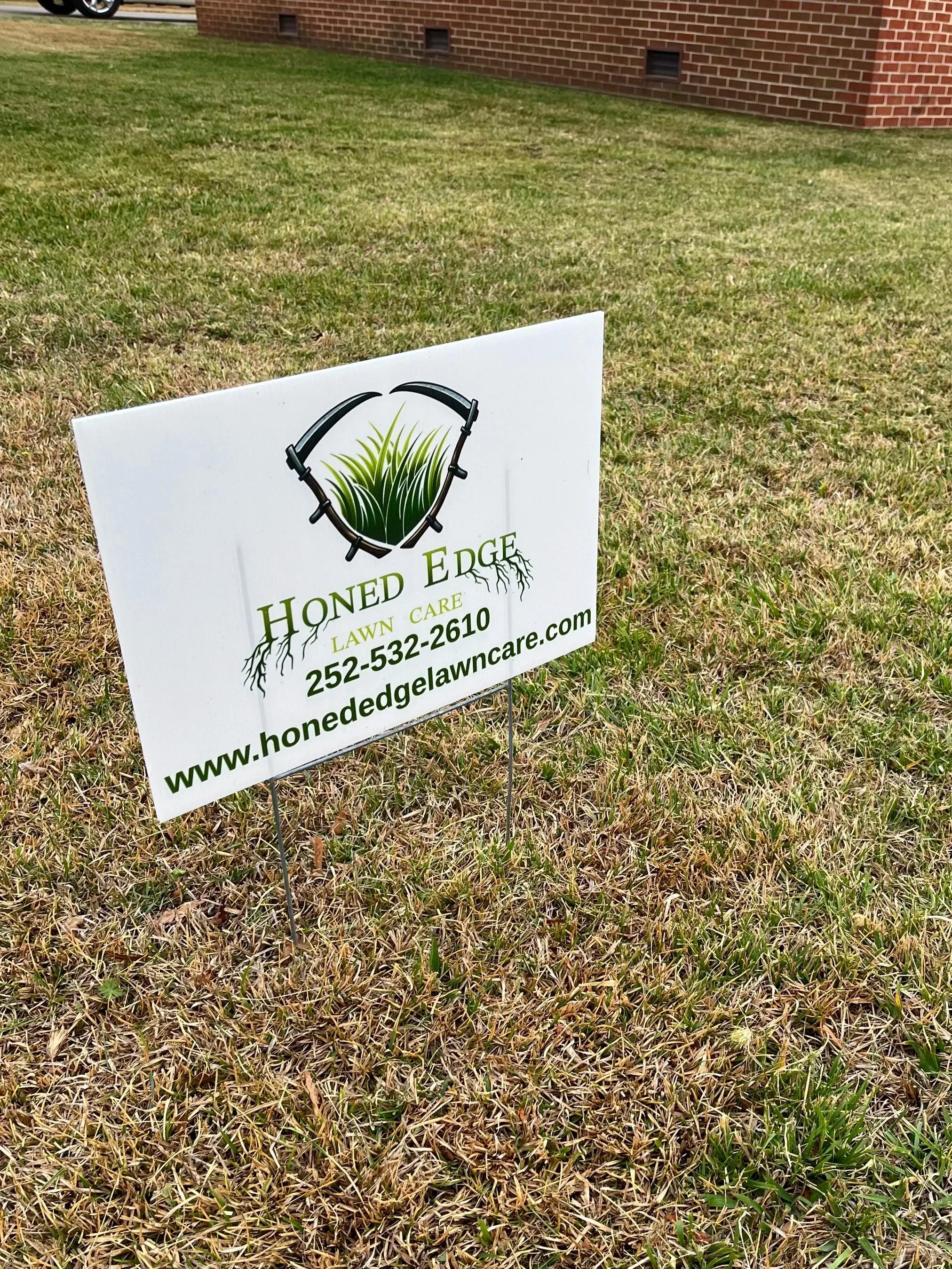 Yard sign for Hone Edgelawn Care with a logo of grass inside a head-shaped outline and contact information
