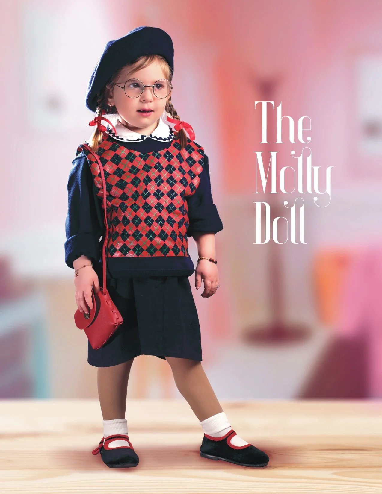 A girl dressed in a Margaret doll costume, wearing a plaid vest, a navy blue beret, glasses, and black shoes with white socks, standing on a wooden surface with a blurred pink and beige background.