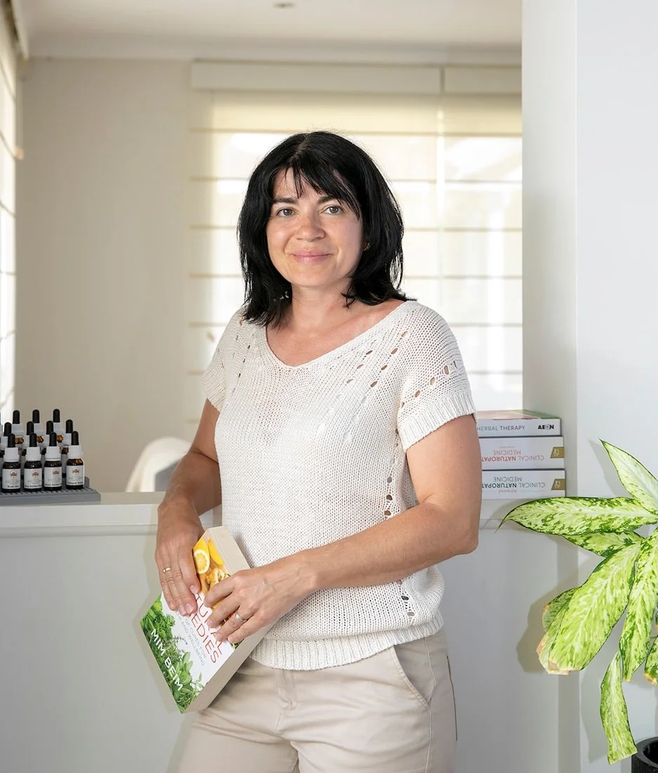 Anita Bordes in a natural light-filled room at The Healing Meadow Naturopathy, exploring nutritional support and lifestyle guidance for hormonal wellbeing.