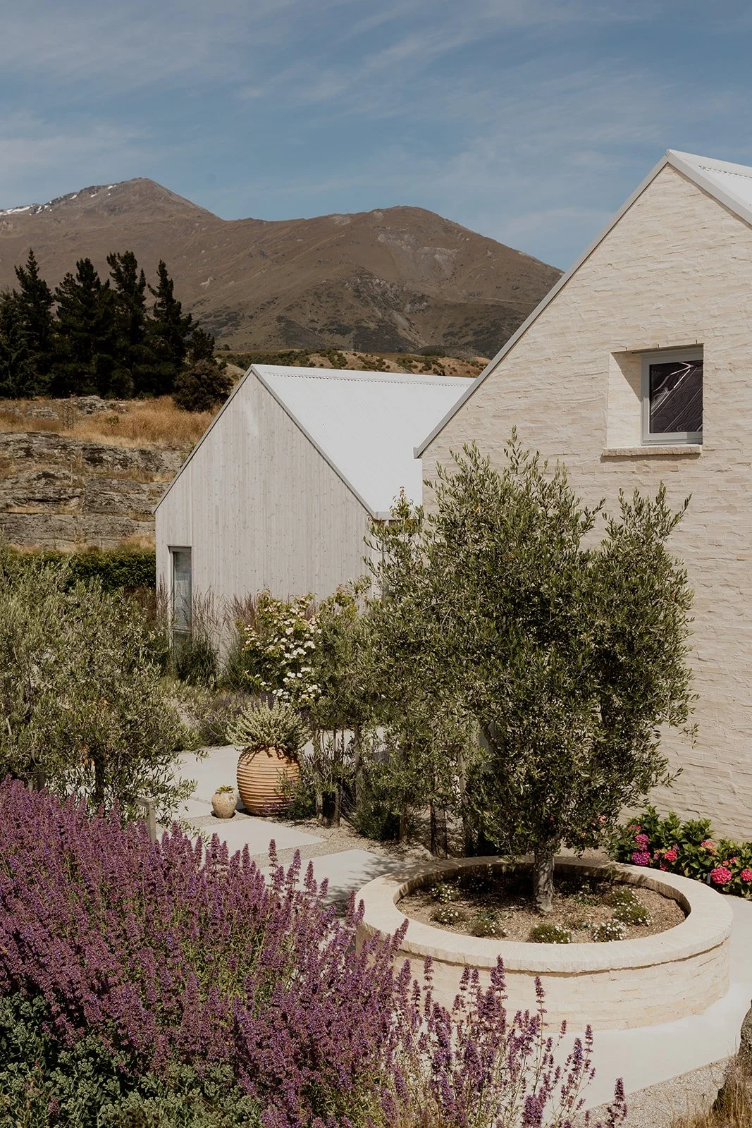 A tuscan style exterior with stand out exterior planting at a Gibbston Valley home built by Diemarco Builders Queenstown.