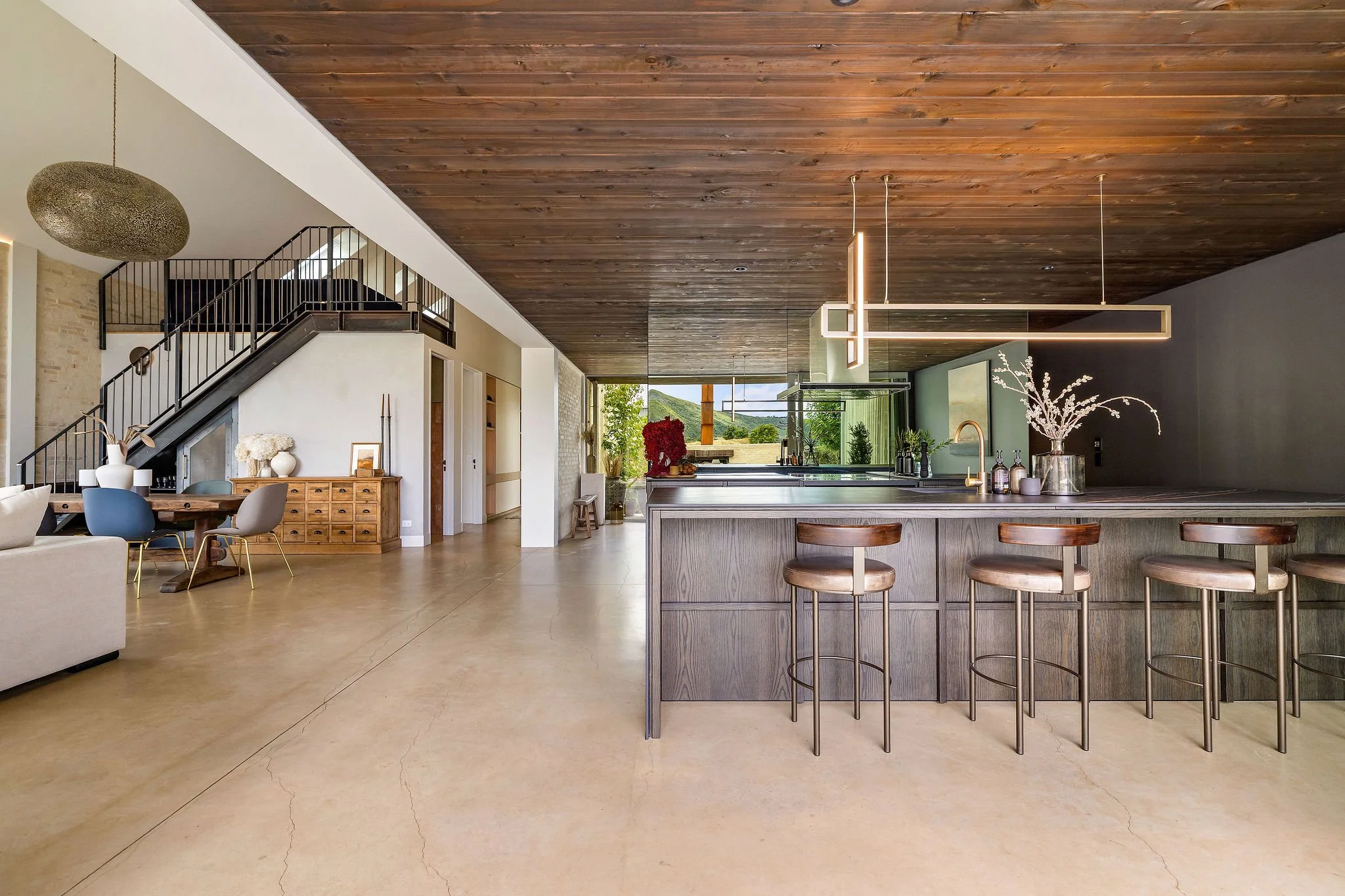 Open plan kitchen and dining space at Peregine Ridge, a Gibbston Valley home built by Diemarco Builders Queenstown.