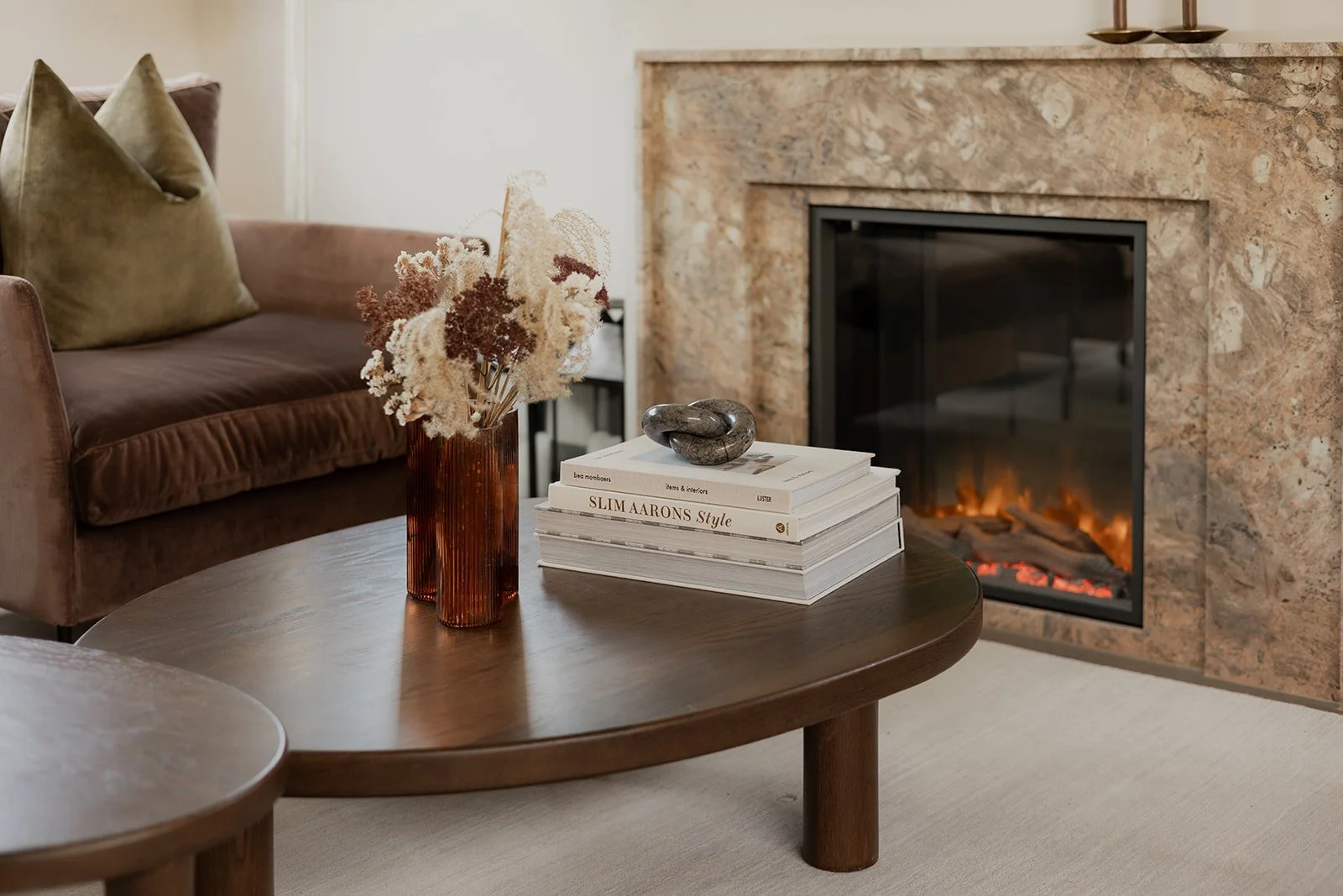 A cosy lounge space with feature fireplace at Northbrook Arrowtown built by Diemarco Builders Queenstown.