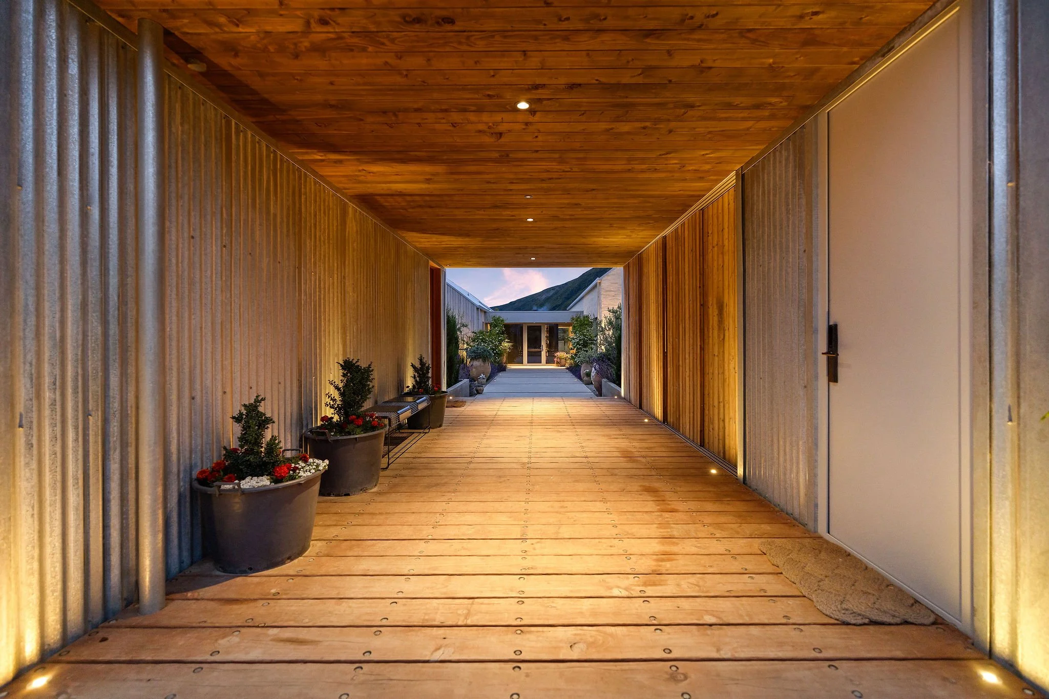 A clever sheltered walkway between the garage sides at Peregine Ridge, a Gibbston Valley home built by Diemarco Builders Queenstown.