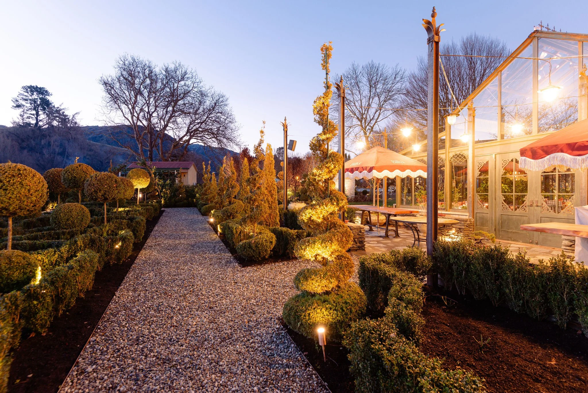 The exterior of the Orangery extension to Billy's Restaurant at Ayrburn in Arrowtown lit up at night, built by Diemarco Builders Queenstown.