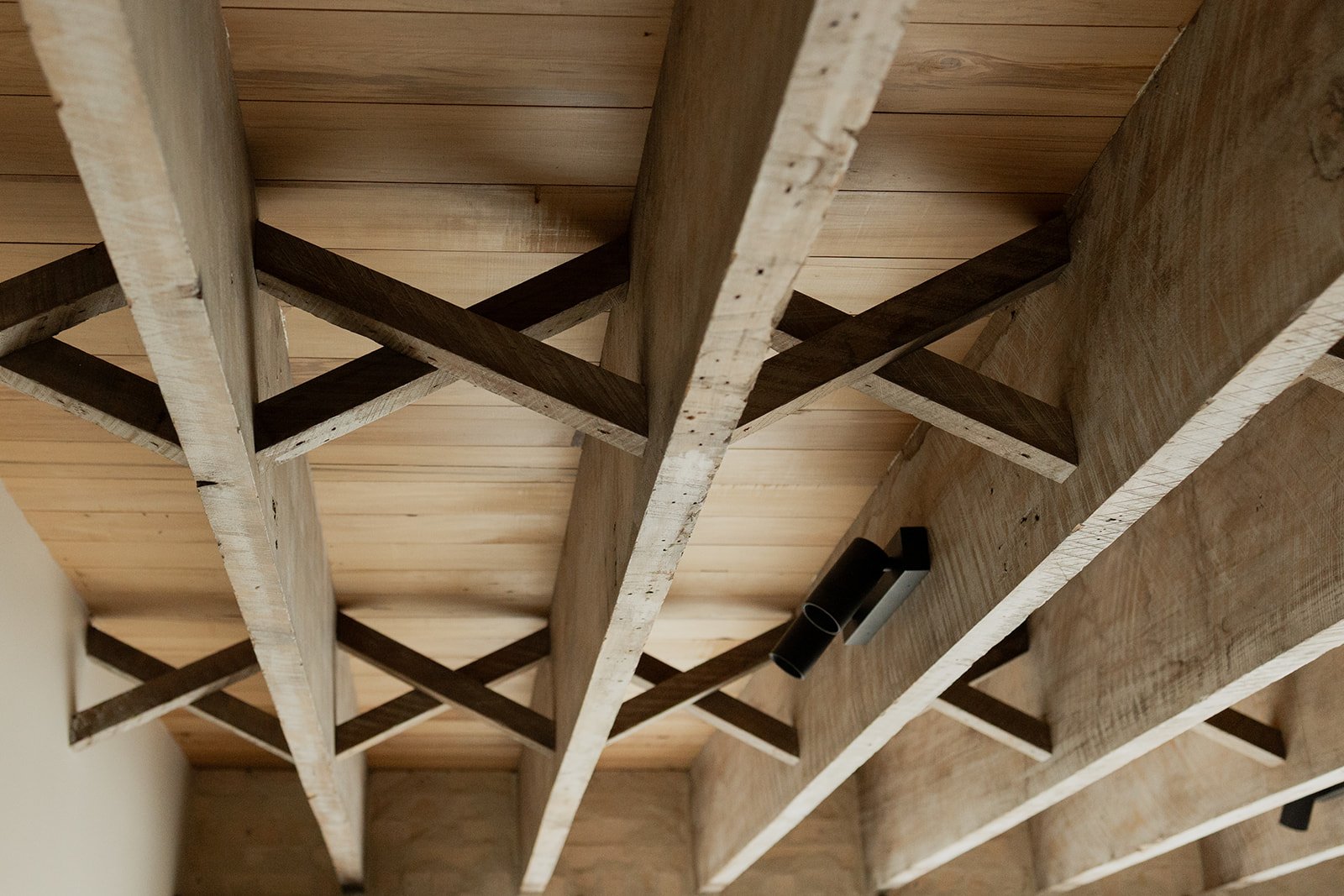 Ceiling craft details with rafters and criss-cross timber detailing built by Diemarco Builders Queenstown.