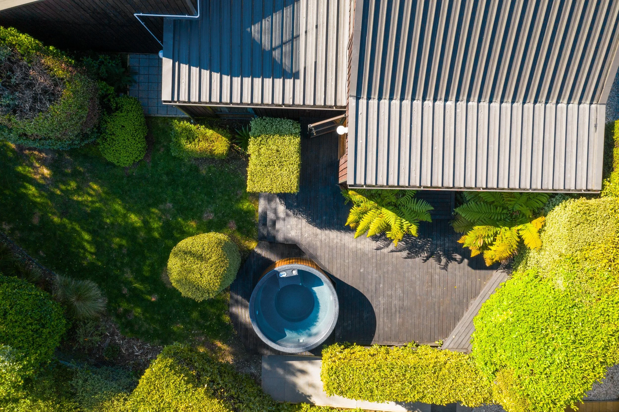 An aerial view of the backyard and hot tub at a residential renovation in Kelvin Heights by Diemarco Builders Queenstown.