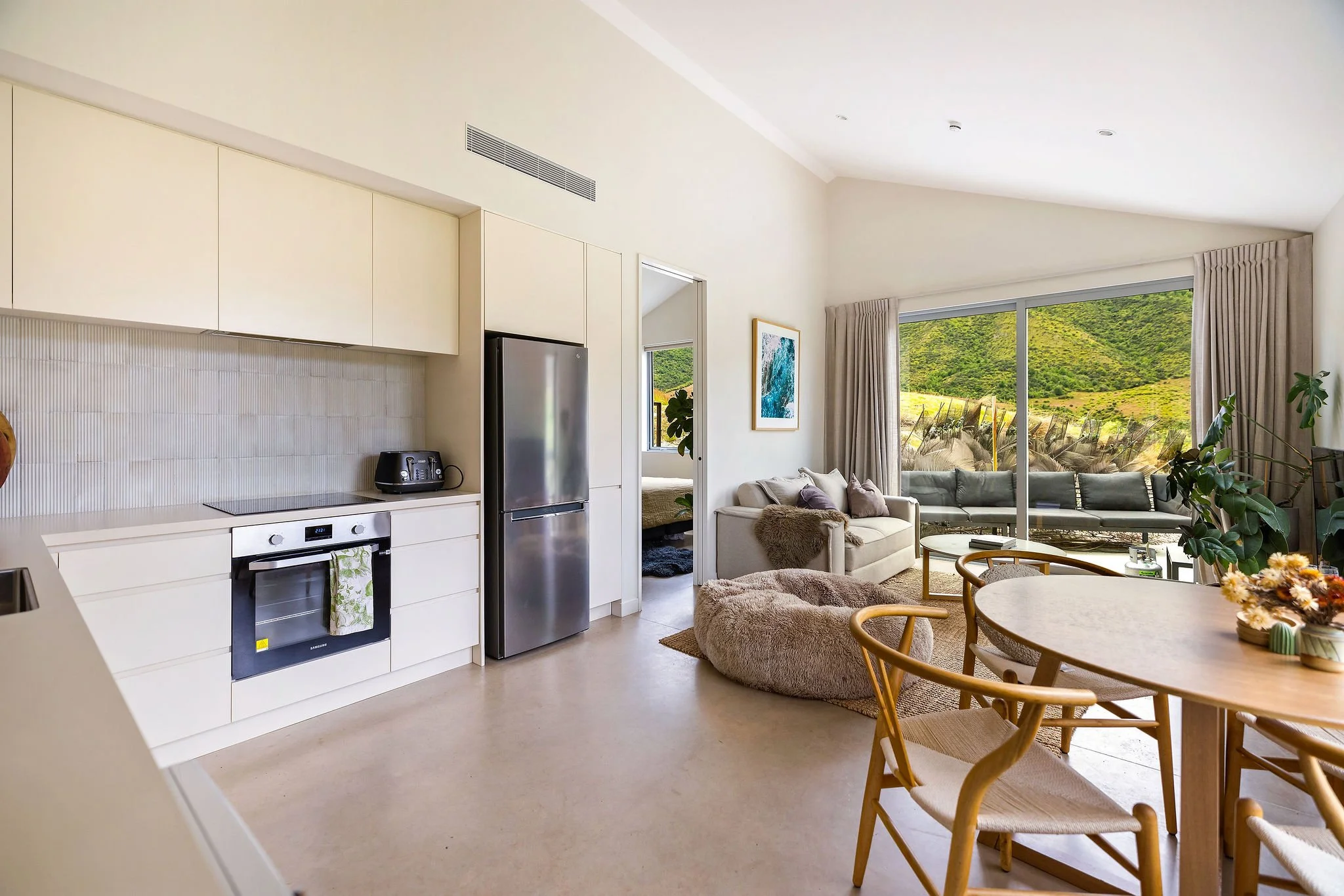 Kitchenette and lounge dining space as part of Peregine Ridge, a Gibbston Valley home built by Diemarco Builders Queenstown.
