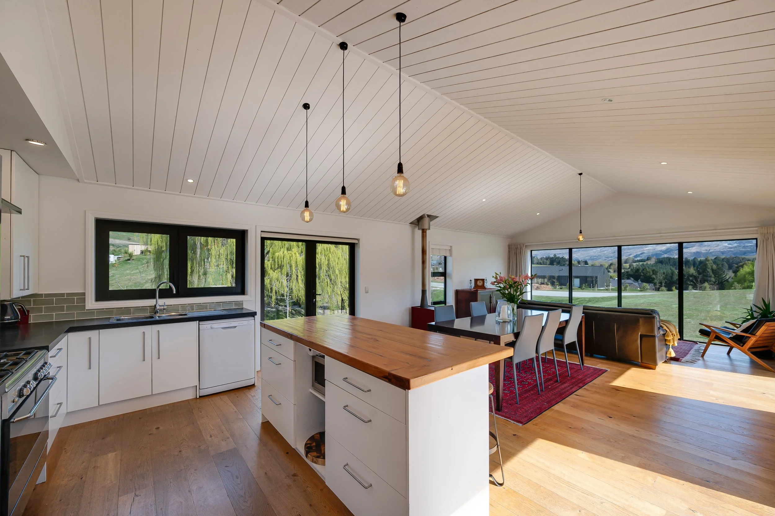 Stunning scissor truss ceilings over top of an open plan kitchen and dining space at a new home build in Threepwood by Diemarco Builders Queenstown.