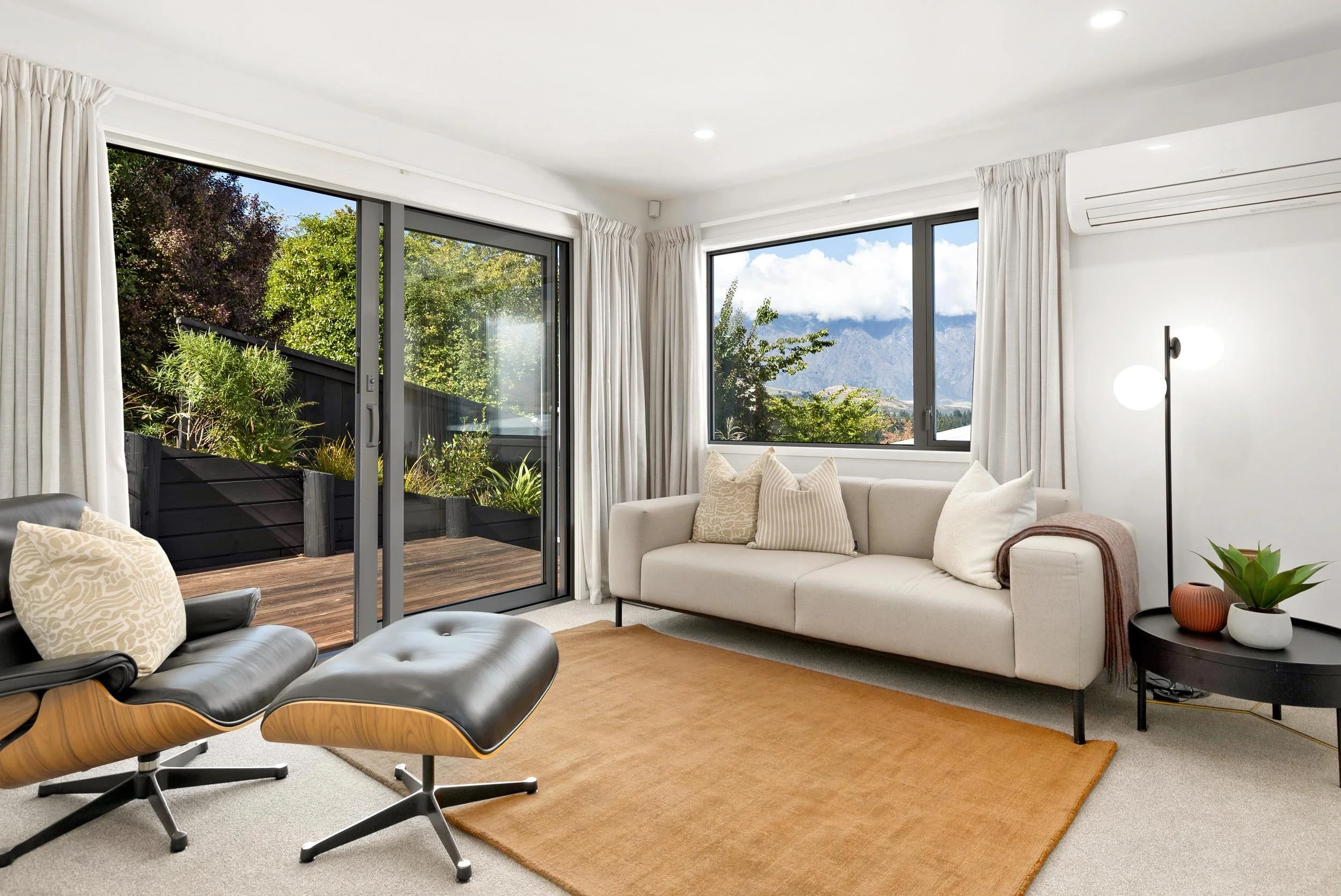 A light and modern lounge area in a renovated townhouse by the team at Diemarco Builders Queenstown.