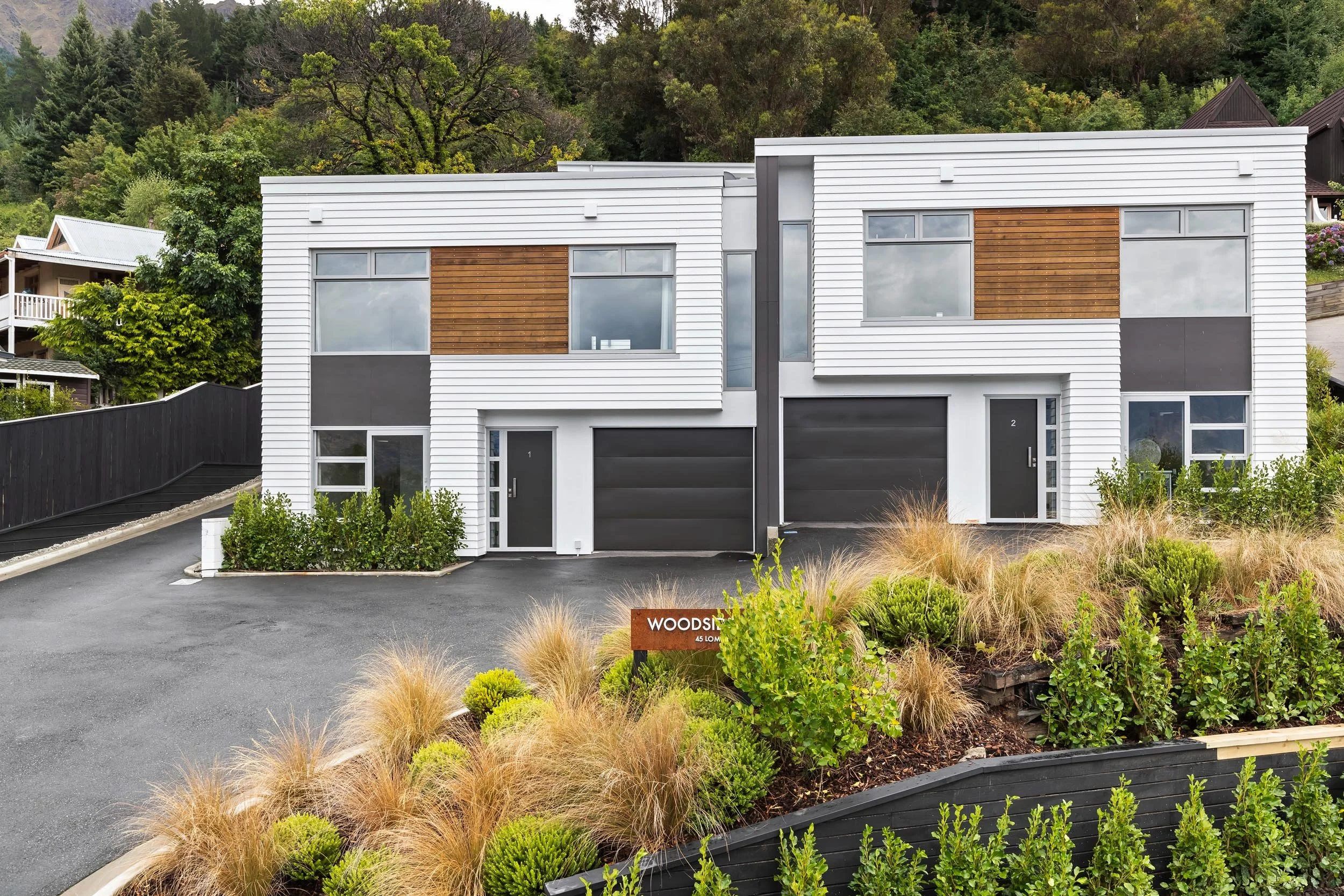 The completely refreshed front exterior of renovated townhouses by the team at Diemarco Builders Queenstown.