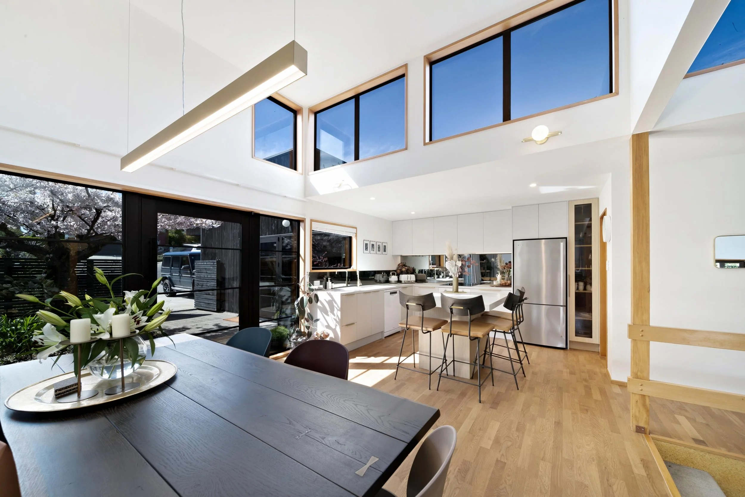 A seamless, fresh and bright kitchen and dining area at a residential renovation in Kelvin Heights by Diemarco Builders Queenstown.