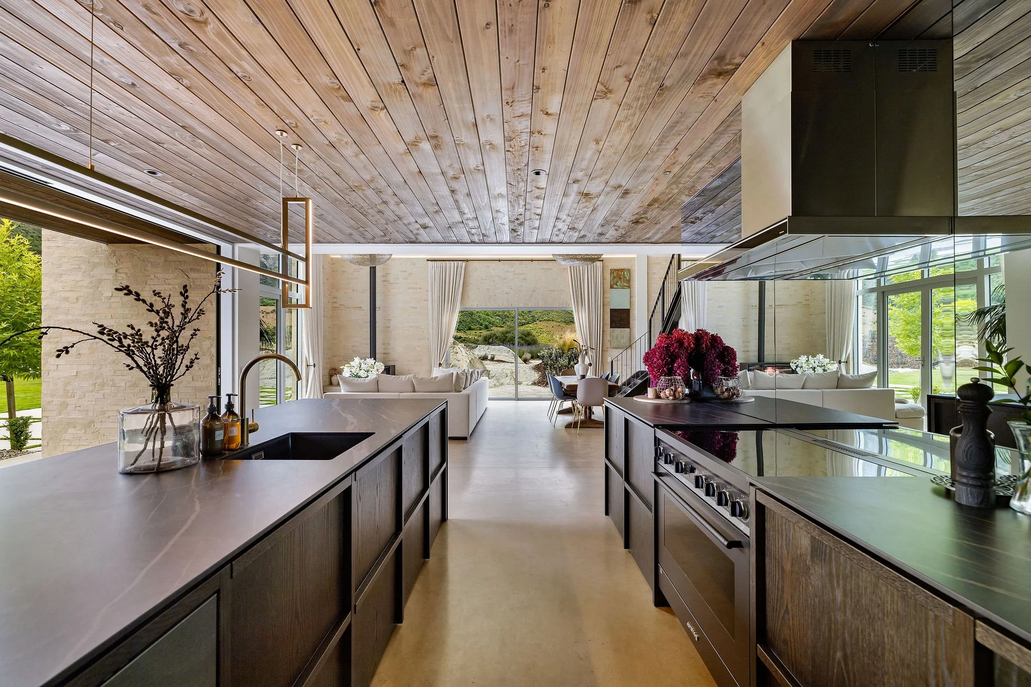 Galley style kitchen with timber ceilings and high end details at Peregine Ridge, a Gibbston Valley home built by Diemarco Builders Queenstown.