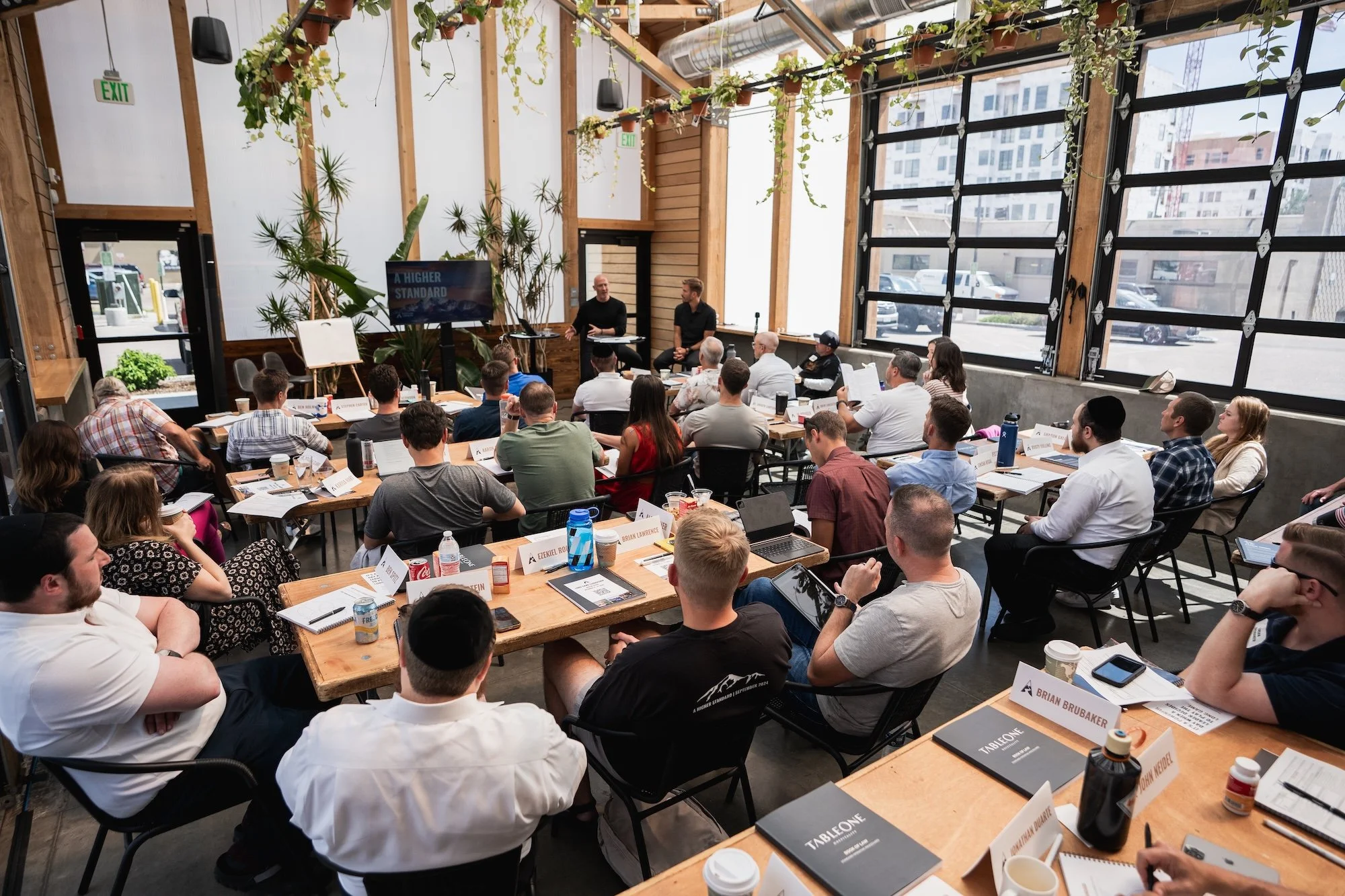 A group of people attending a workshop or business seminar in a modern, well-lit room in Kalispell, Montana in the Flathead Valley