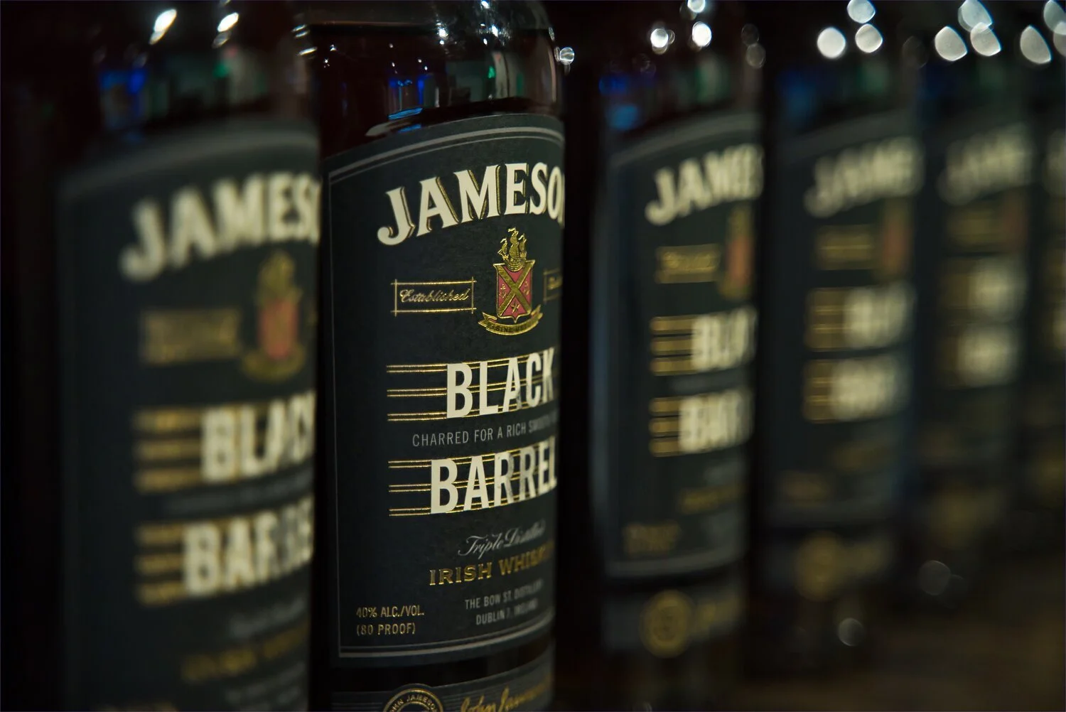 Bottles of Jameson Black Barrel Irish Whiskey lined up on a shelf. Product Photographer in Kalispell, Montana in the Flathead Valley