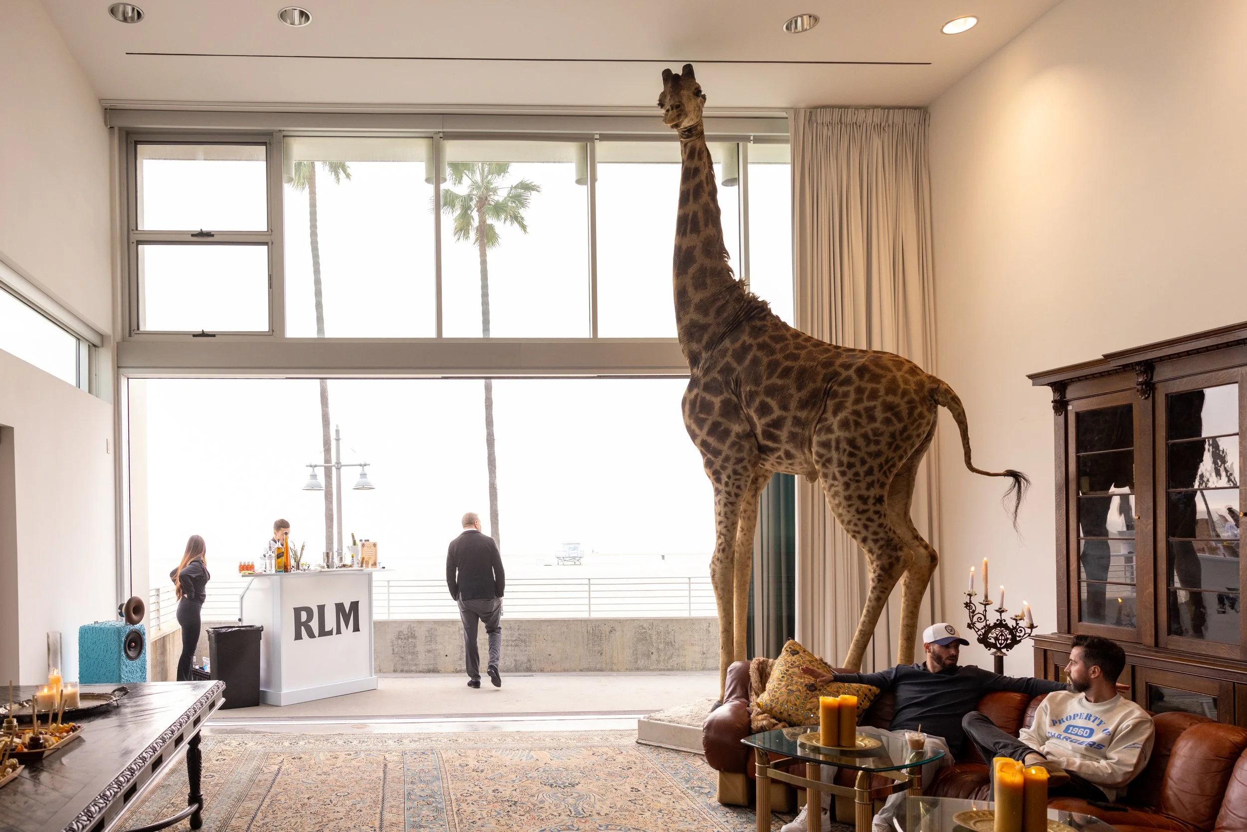 Event space at The Lofts Venice Beach with taxidermy giraffe and ocean-view lounge