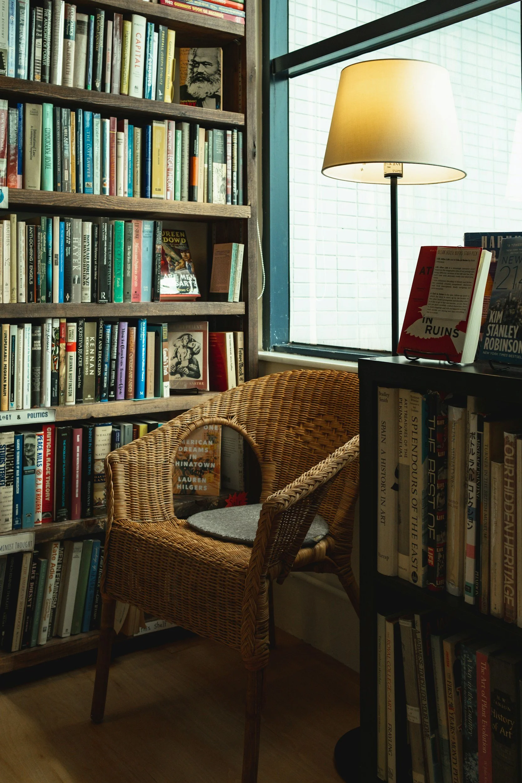 Cozy reading chair beside bookshelves and warm lighting in a calming therapy office space
