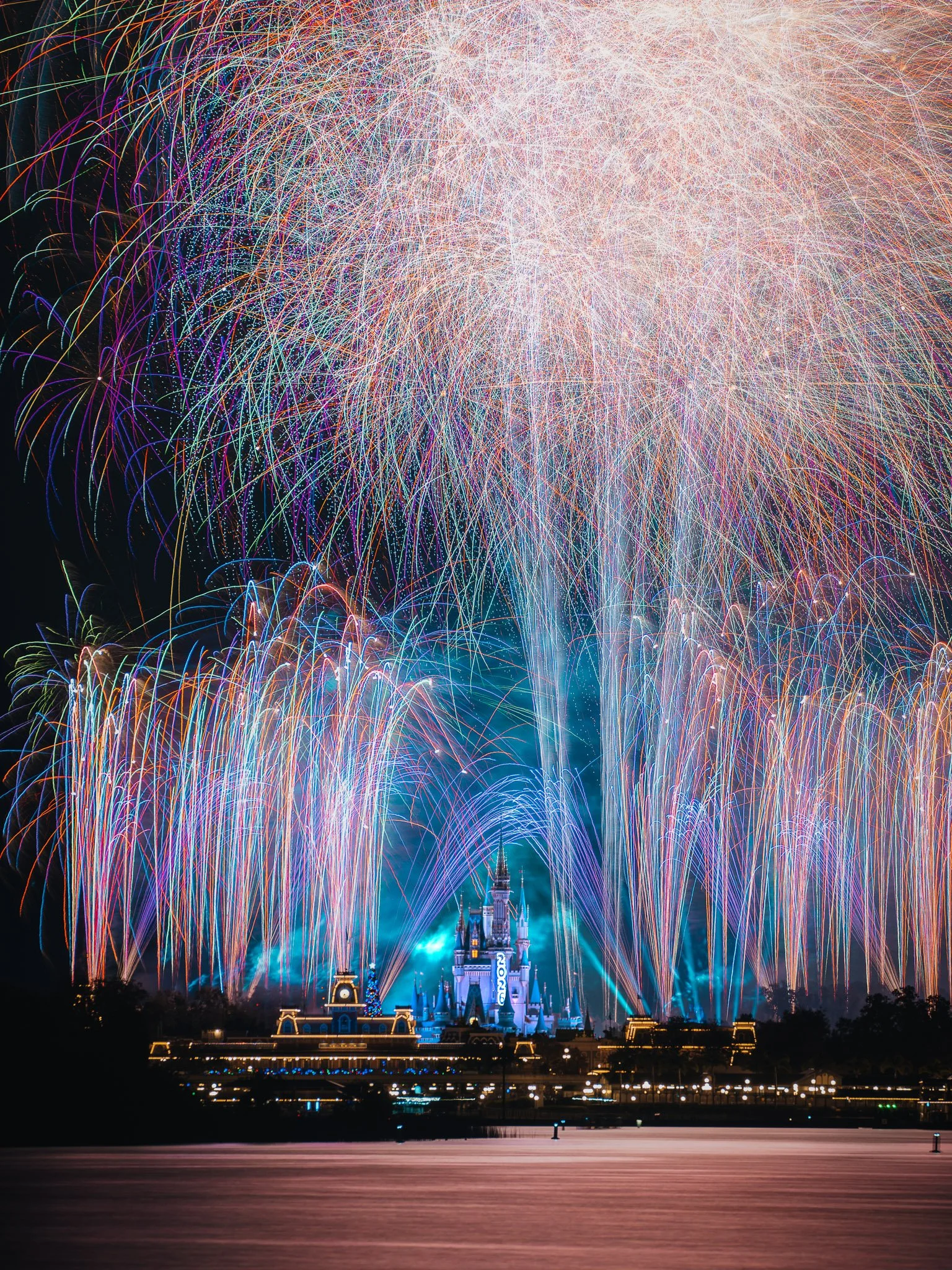 Fireworks display over a castle at night.