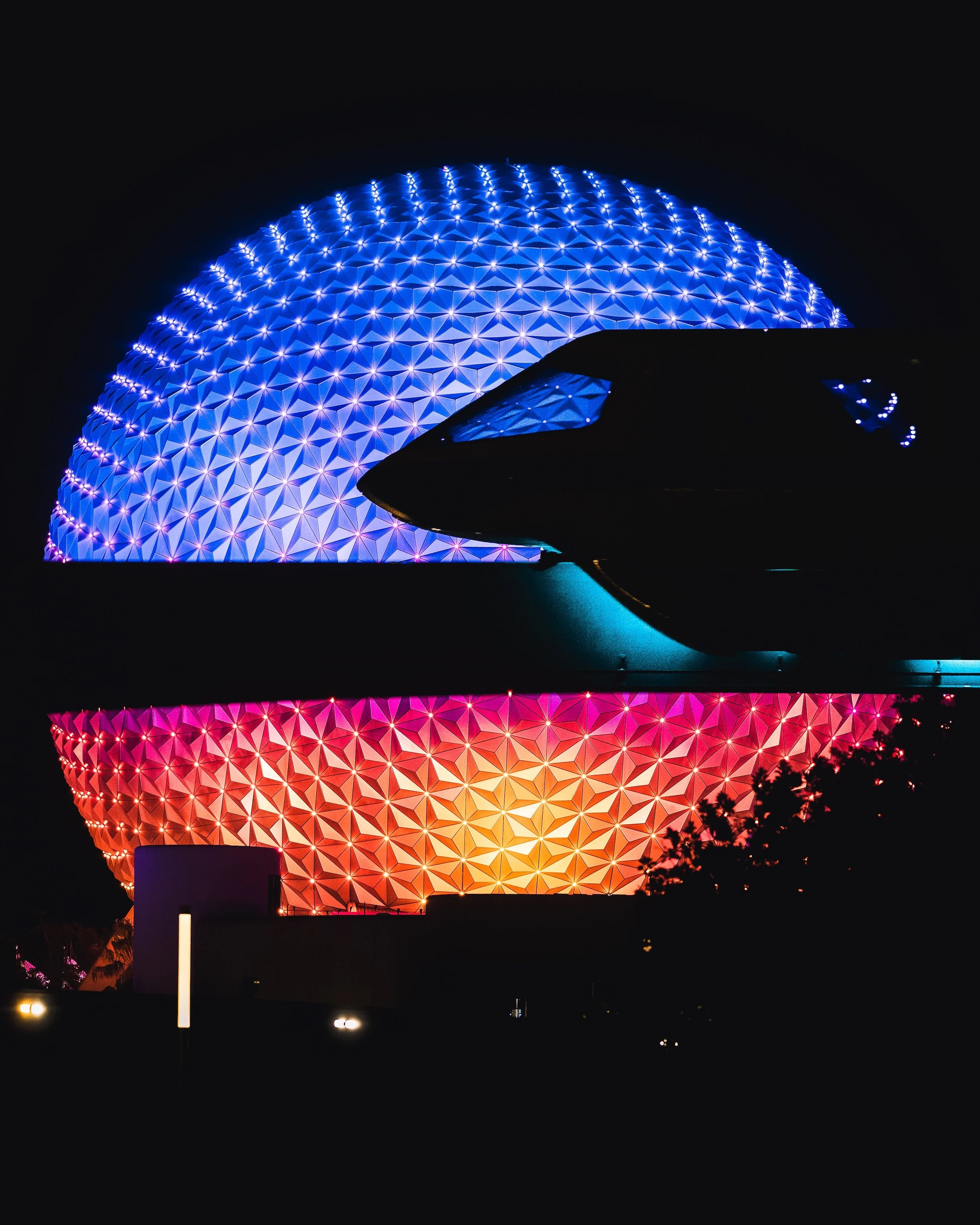Nighttime view of Spaceship Earth at EPCOT illuminated with vibrant purple, pink, orange, and yellow lights.