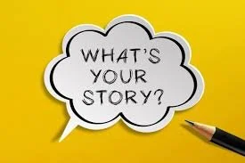 A speech bubble on yellow paper asking, 'WHAT'S YOUR STORY?', with a black pen nearby.